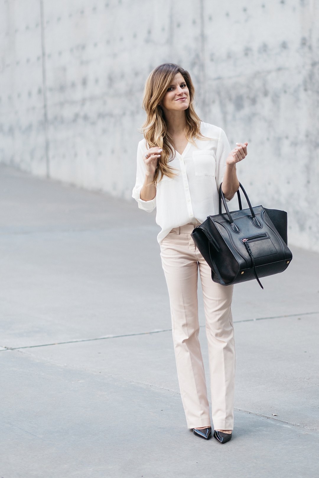 business casual outfit, express editor barely bootcut pants, blush pink pants with off white blouse, express work clothing. business casual outfit idea, prada black patent pumps, black pumps with blush pants, celine phantom bag