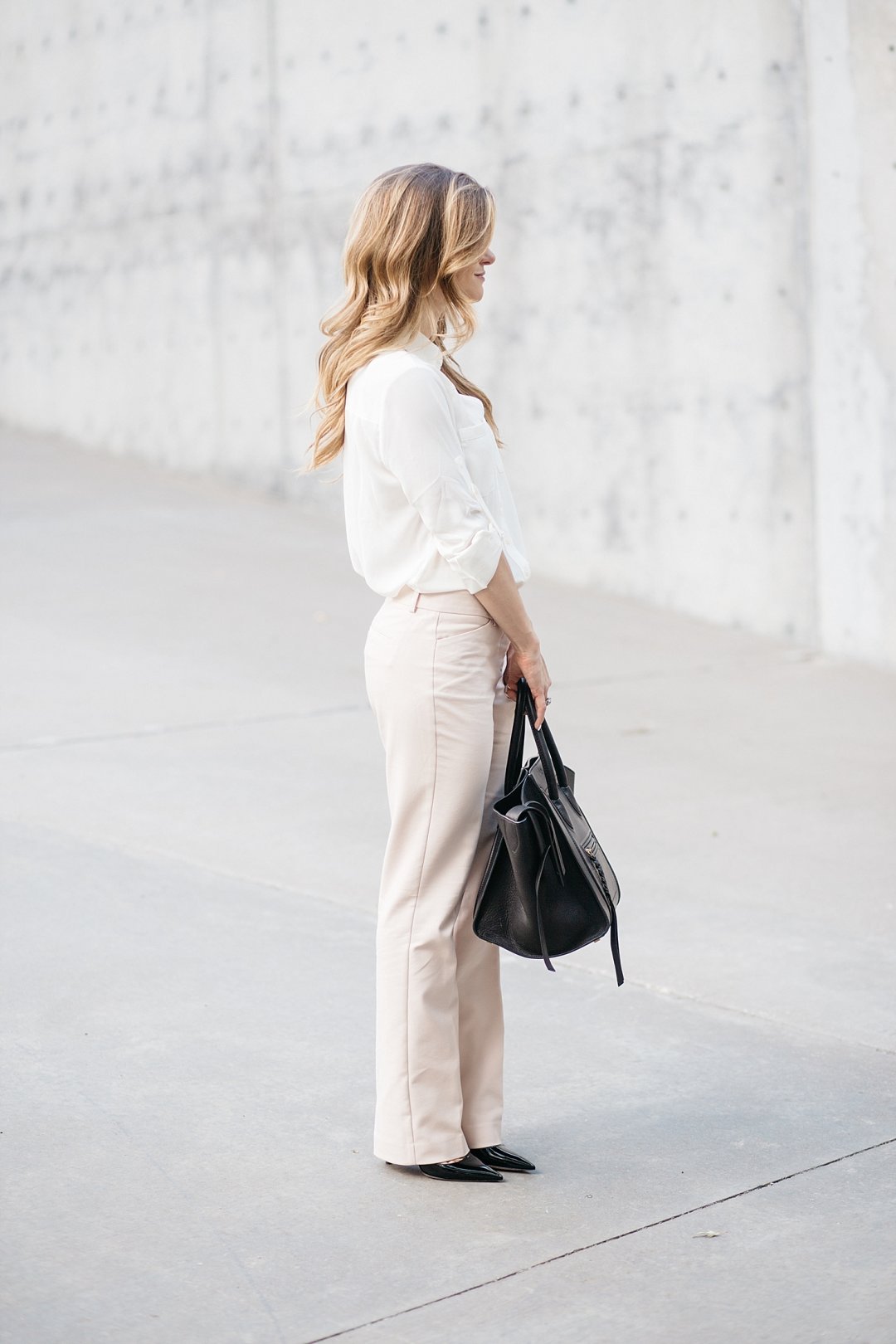 business casual outfit, express editor barely bootcut pants, blush pink pants with off white blouse, express work clothing. business casual outfit idea, prada black patent pumps, black pumps with blush pants, celine phantom bag