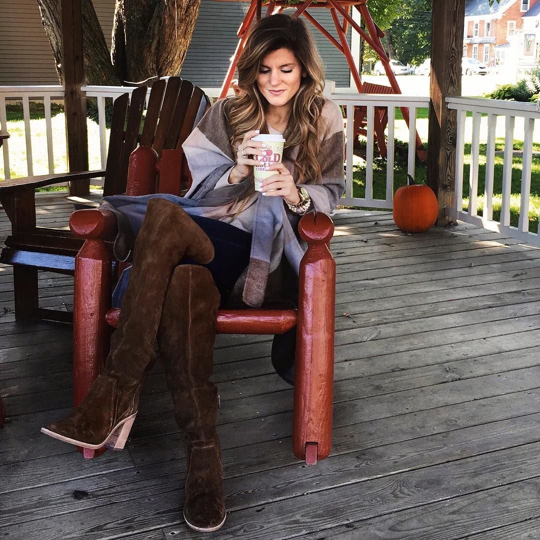 cozy fall outfit, cider, brown tall boots, cape