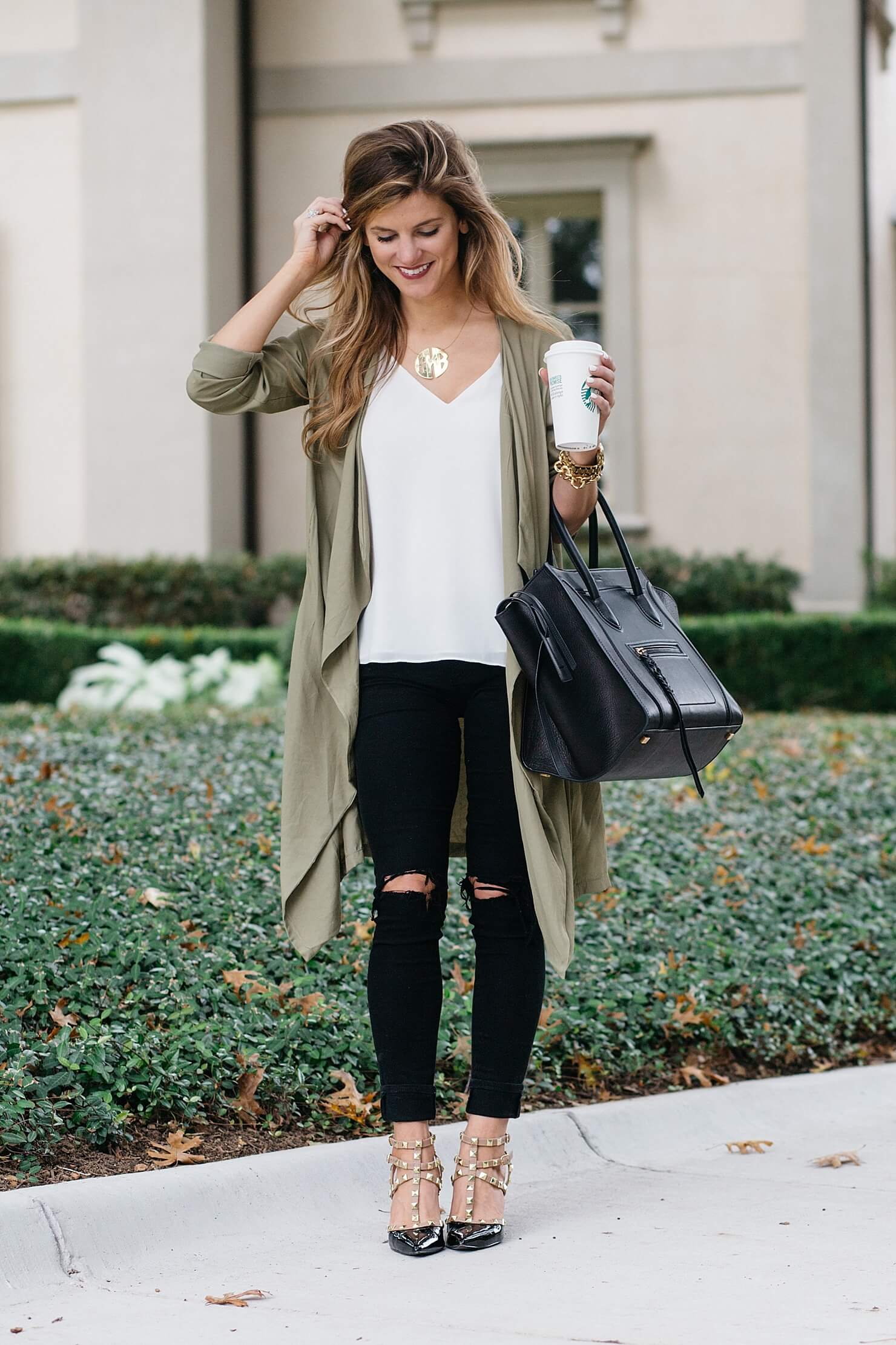 olive green trench outfit, snappy casual outfit with dupe valentino heels, monogram necklace, celine phantom tote, topshop white camisole, black distressed jeans, fall outfit