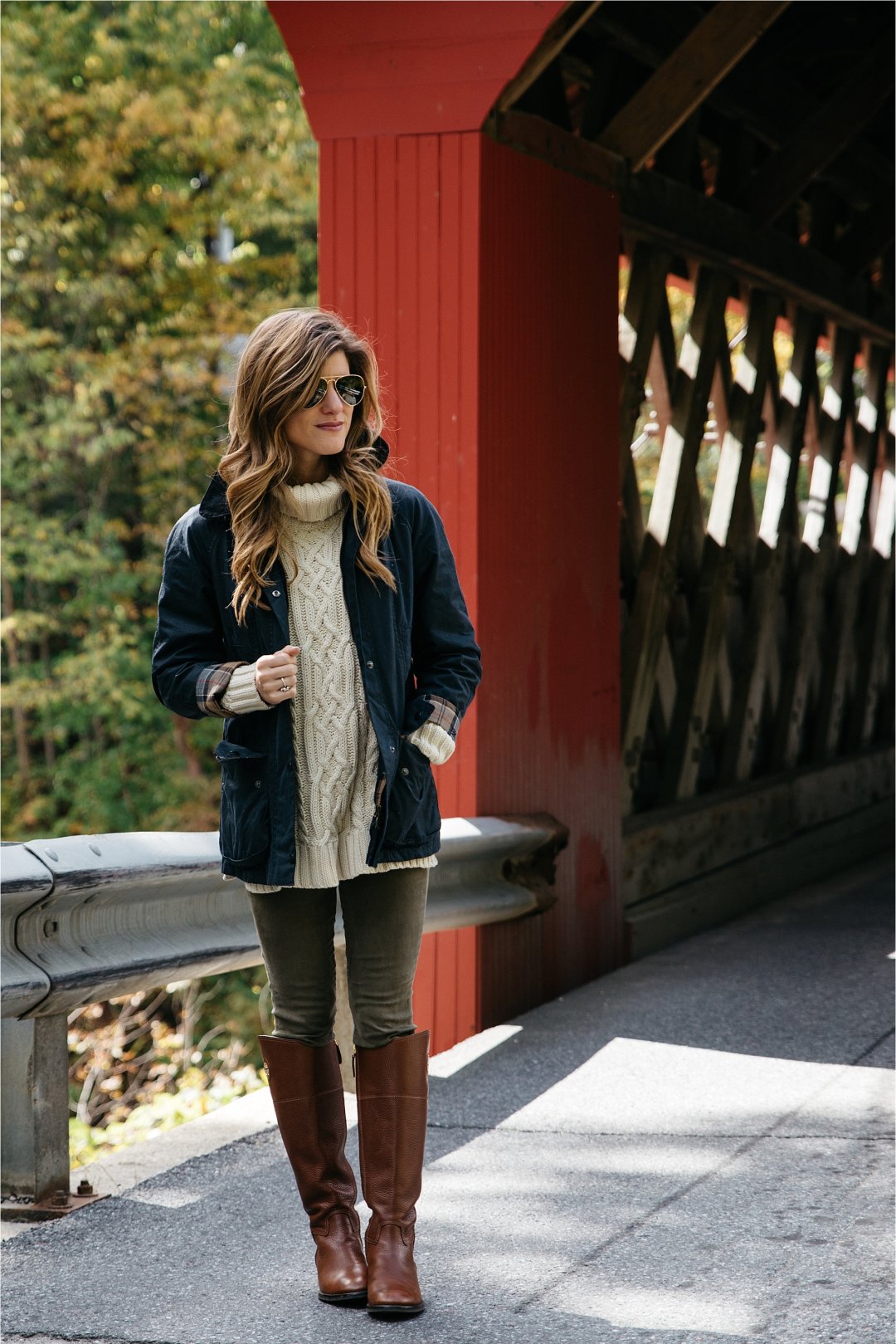 Fall outfit, tory burch riding boots, barbour jacket, olive green pants, oversized cableknit turtleneck sweater