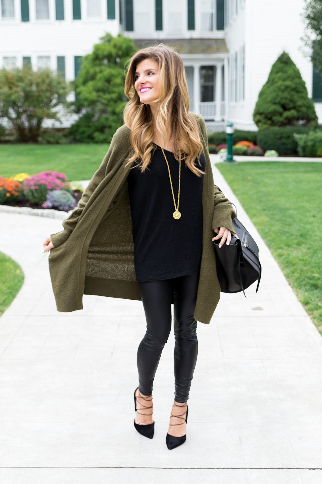 all black outfit idea, wearing all black with a long olive cardigan, liquid leather leggings winter outfit, black on black outfit, going out winter outfit, winter date night outfit, celine phantom tote, sam edelman strappy heels, winter all black outfit