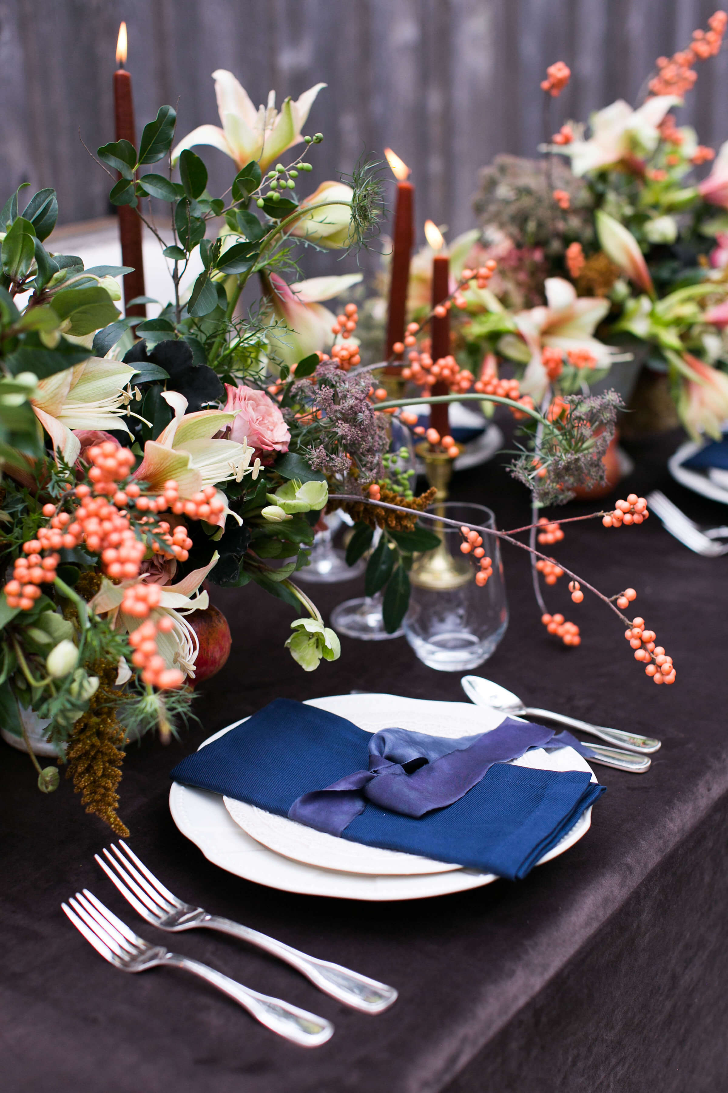 close up view of friendsgiving table setting and floral arrangements