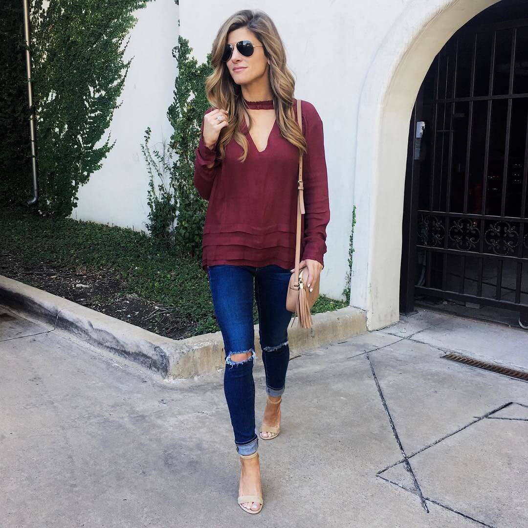 Brighton the day wearing wine long sleeve top, distressed jeans, nude accessories