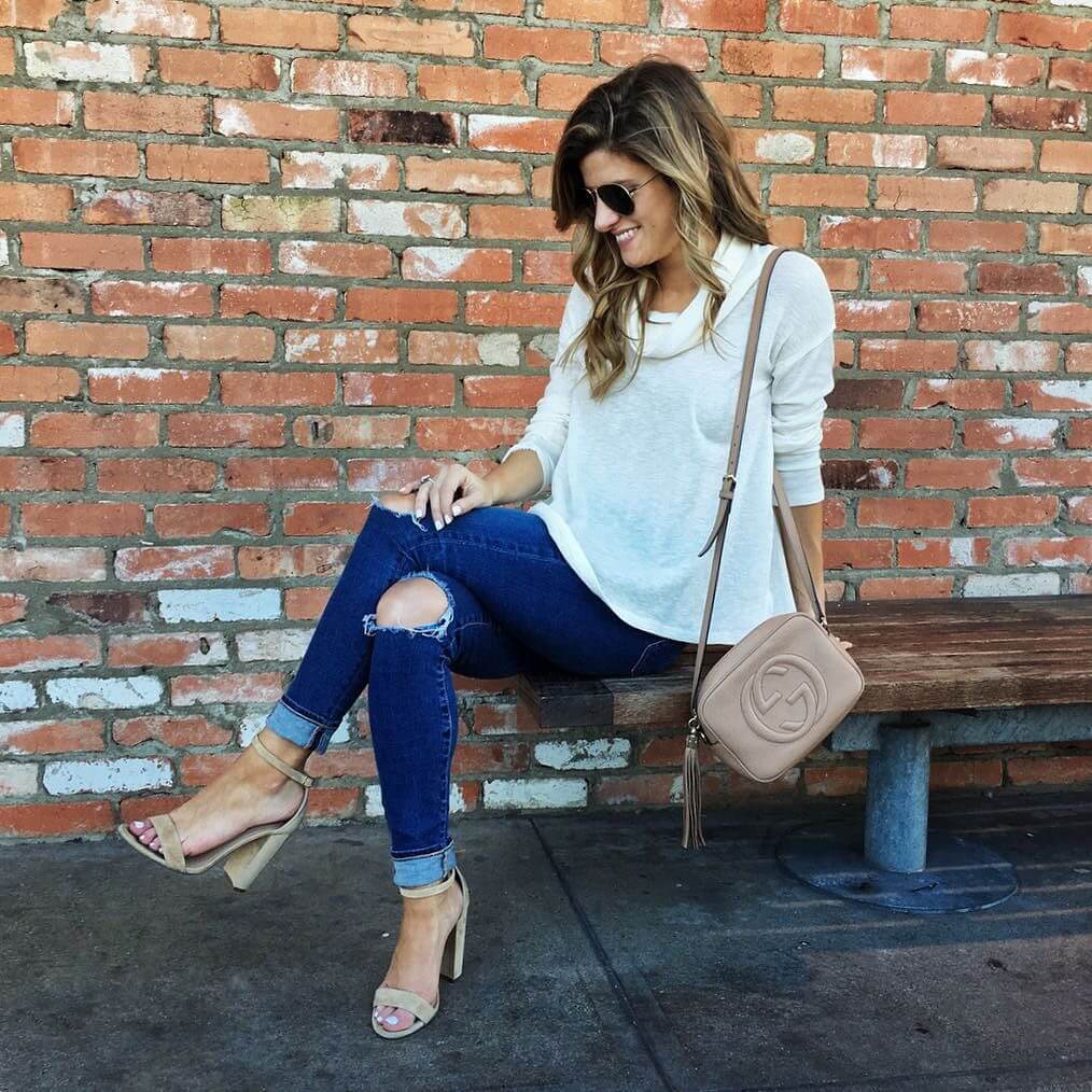 Brighton the day wearing nude heels, distressed jeans, white top, tan gucci crossbody