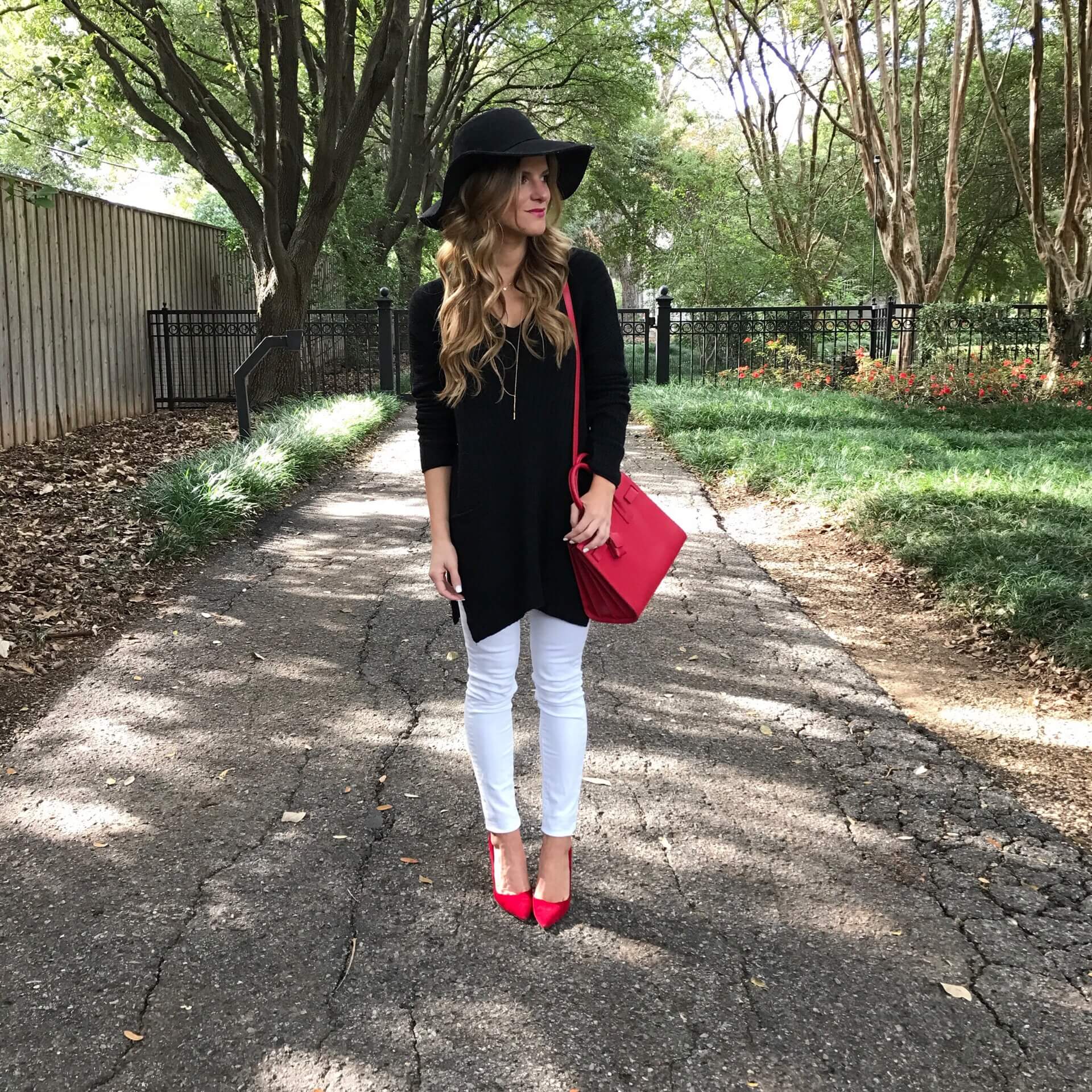 christmas outfit ideas, white jeans black tunic sweater, ysl red sac du jour winter outfit idea