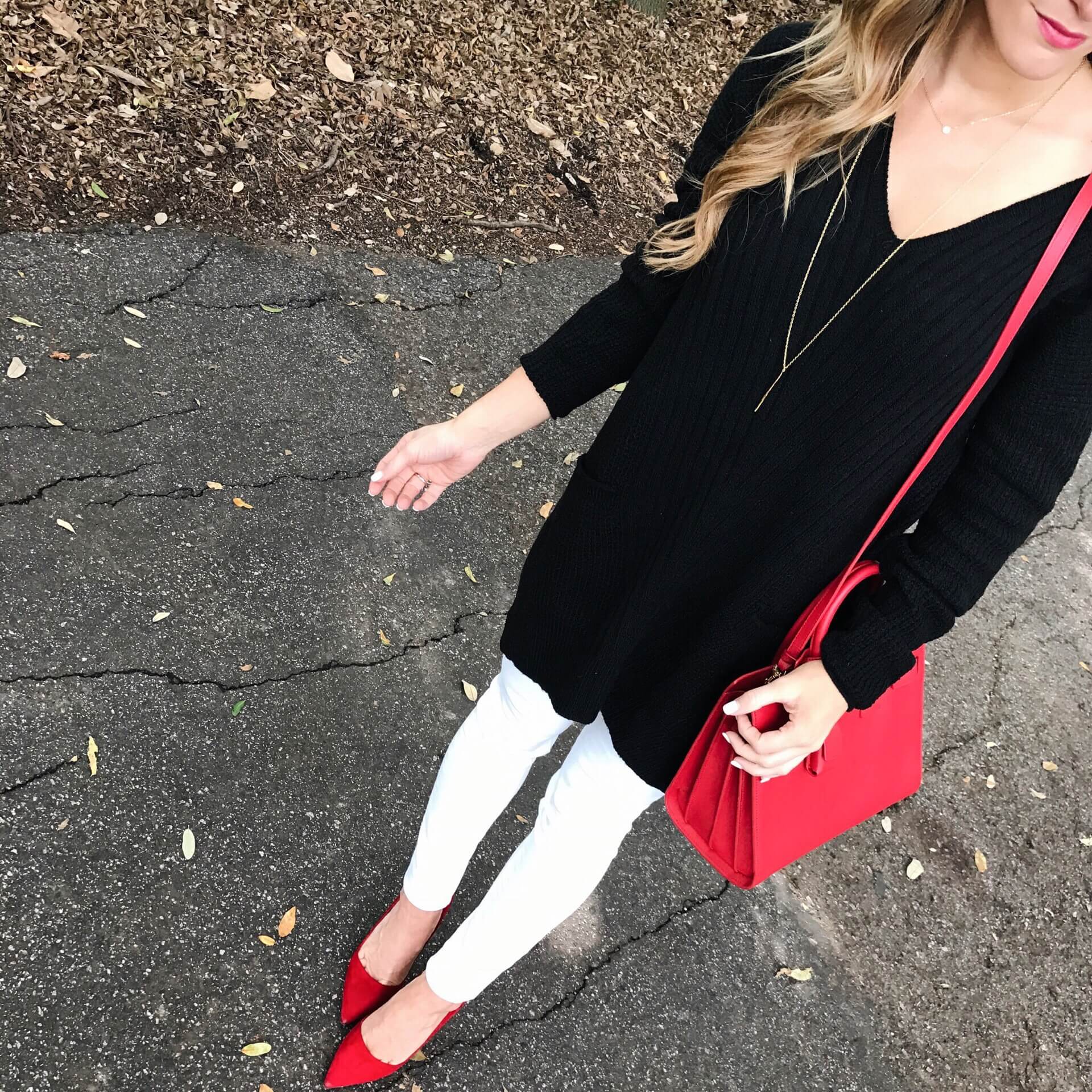 christmas outfit ideas, white jeans black tunic sweater, ysl red sac du jour winter outfit idea
