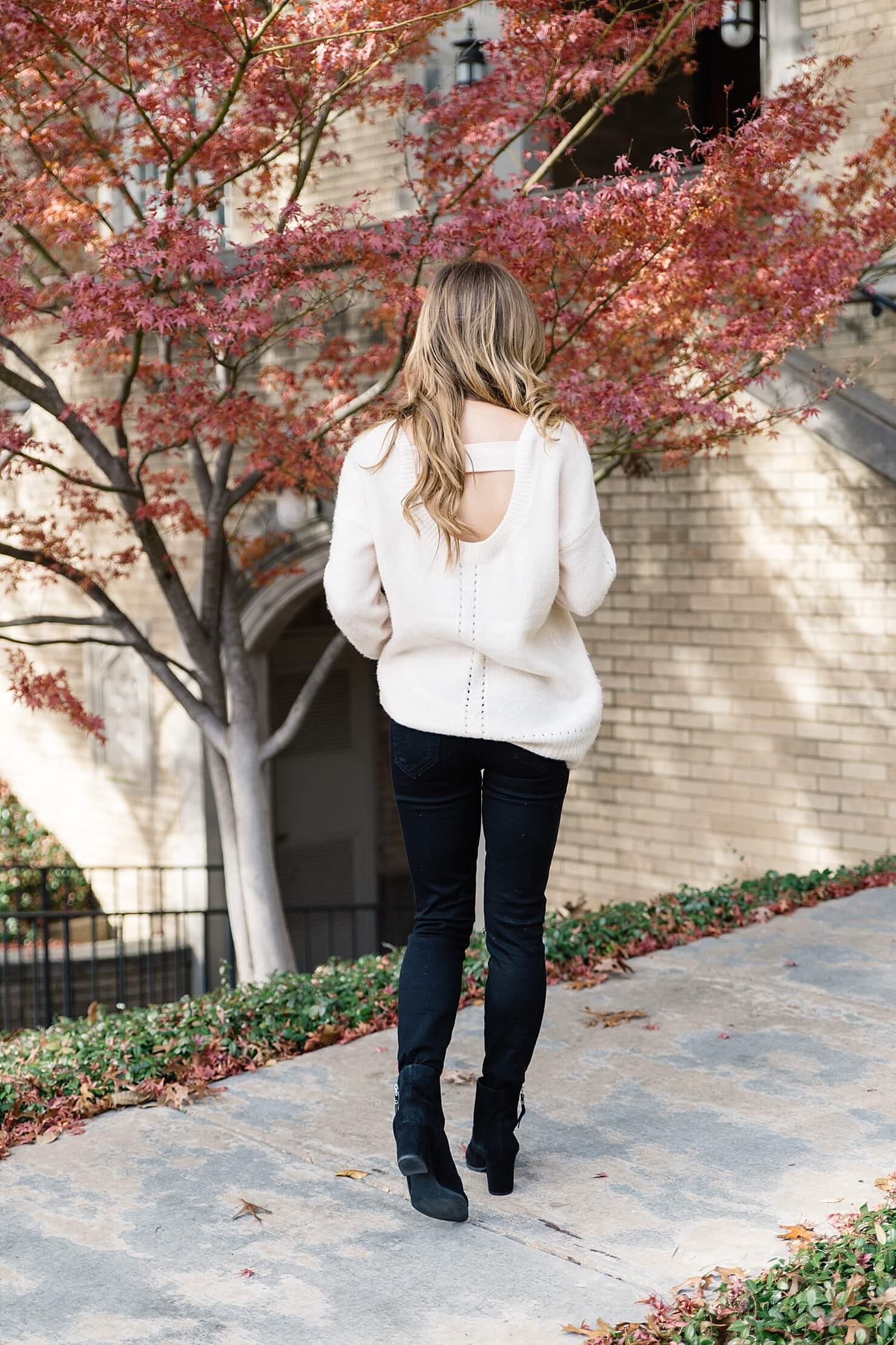 oversized cream sweater with black jeans, open back oversized sweater, black jeans and black booties