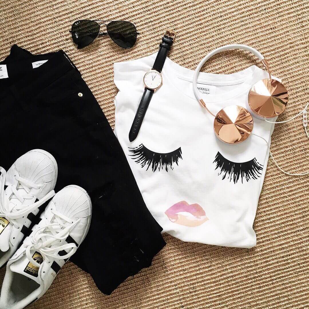 sincerely jules t shirt flat lay picture, adidas, aviators, headphones, black jeans