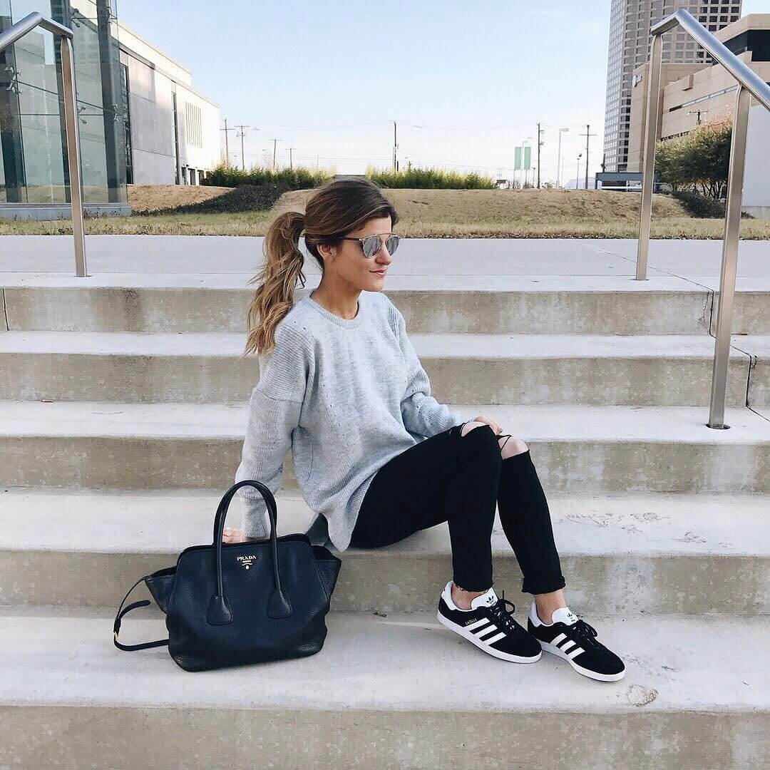 comfy saturday outfit, oversized grey sweater distressed black jeans, adidas black gazelle sneakers, laid back pony tail