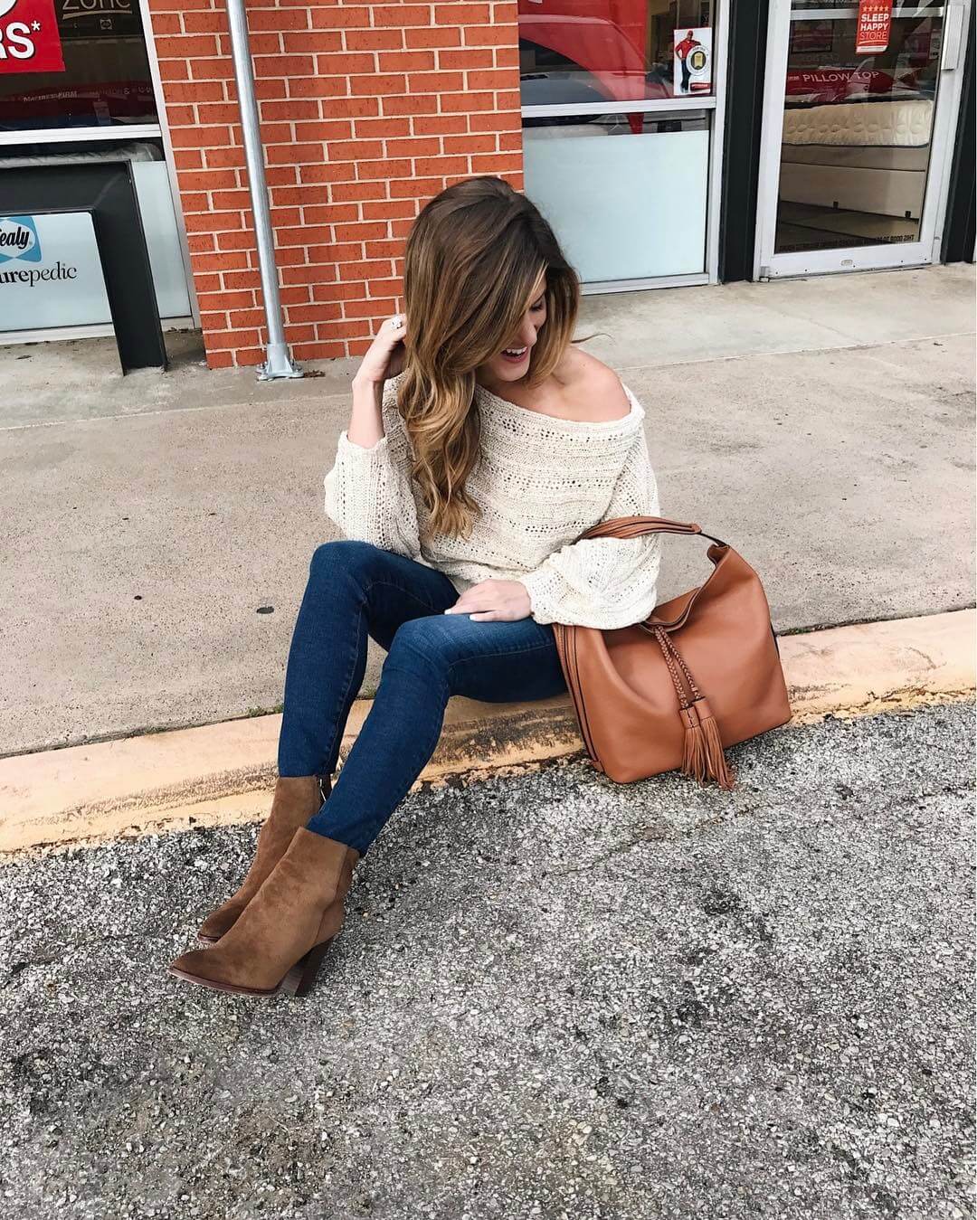 brighton the day styling jeans, bootie, hobo bag, and off the shoulder sweater