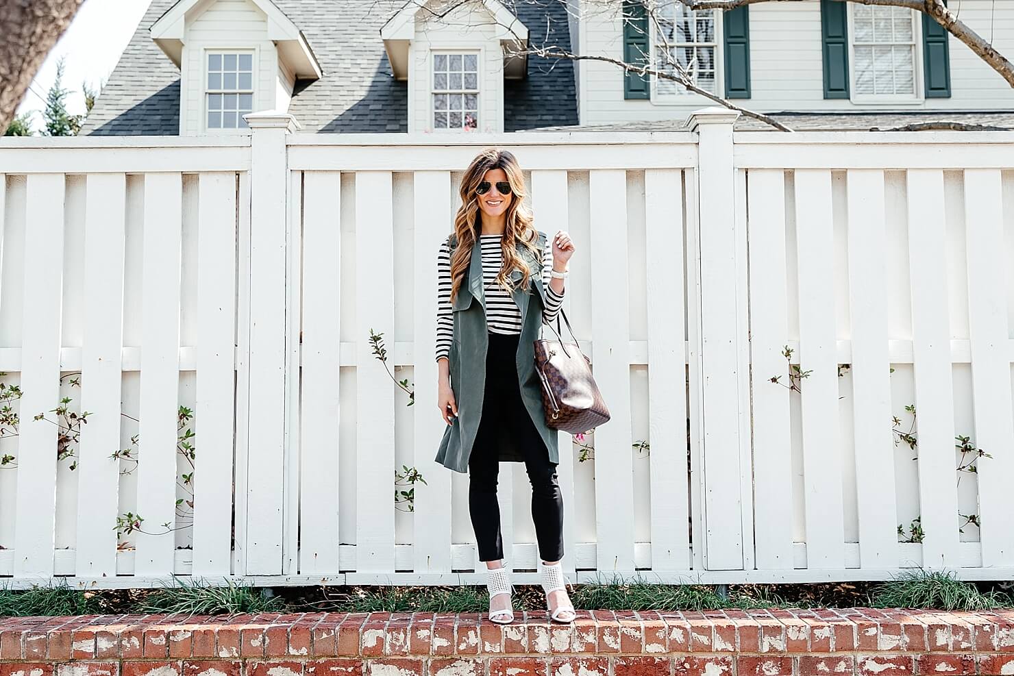 green trench vest, striped tee, black pants 32