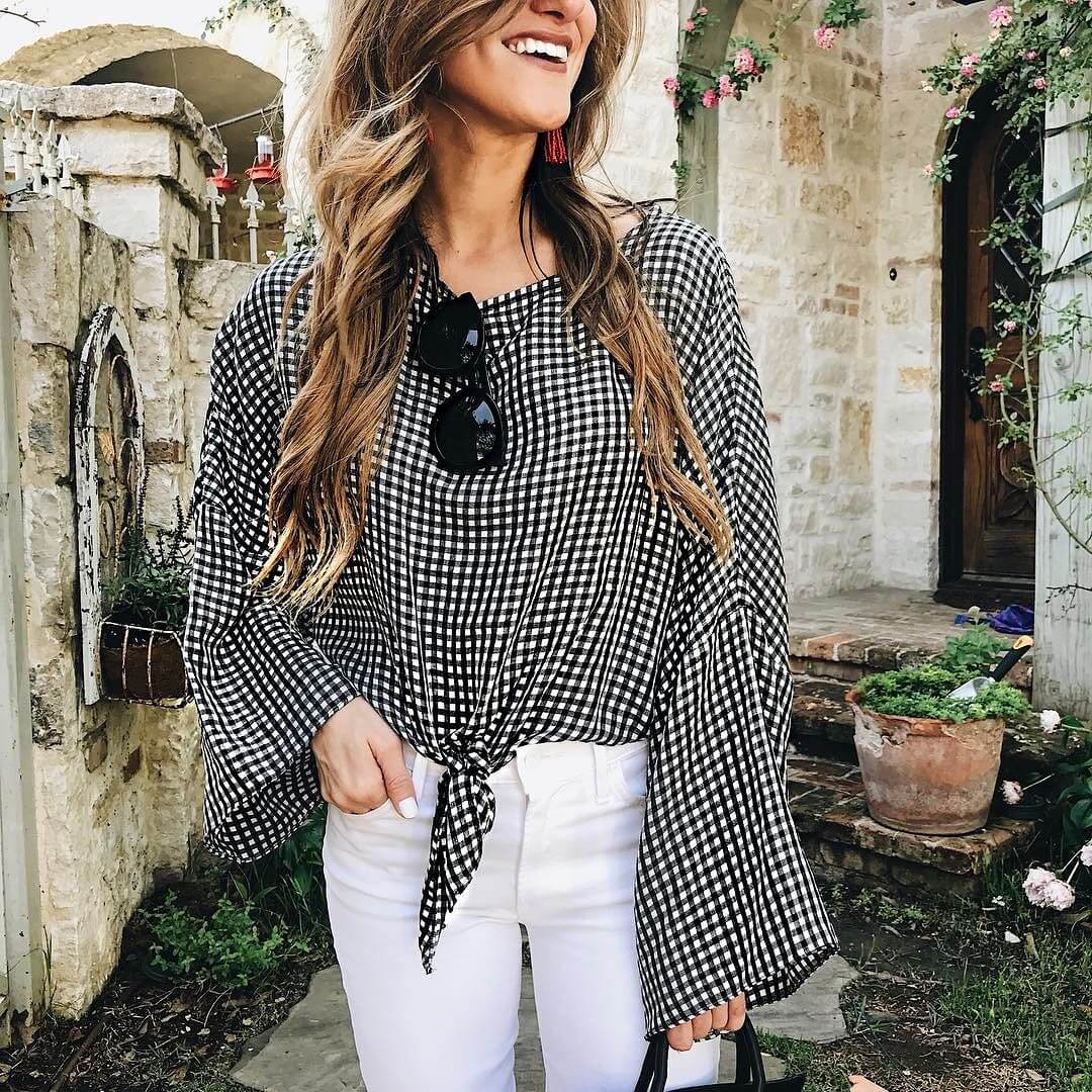brighton keller wearing gingham top with white jeans and black sunglasses 