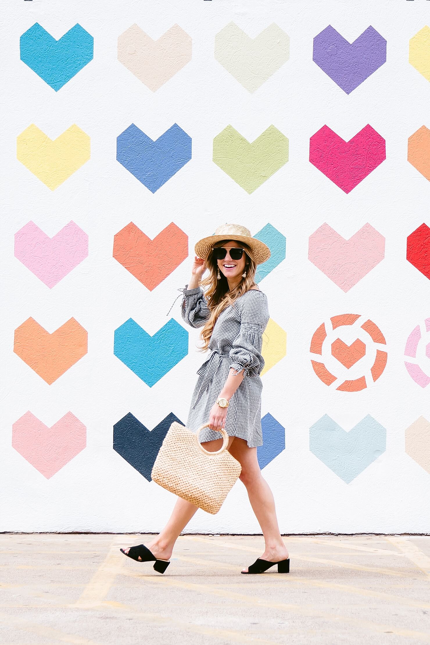 brighton keller wearing gingham dress with mules and straw bag