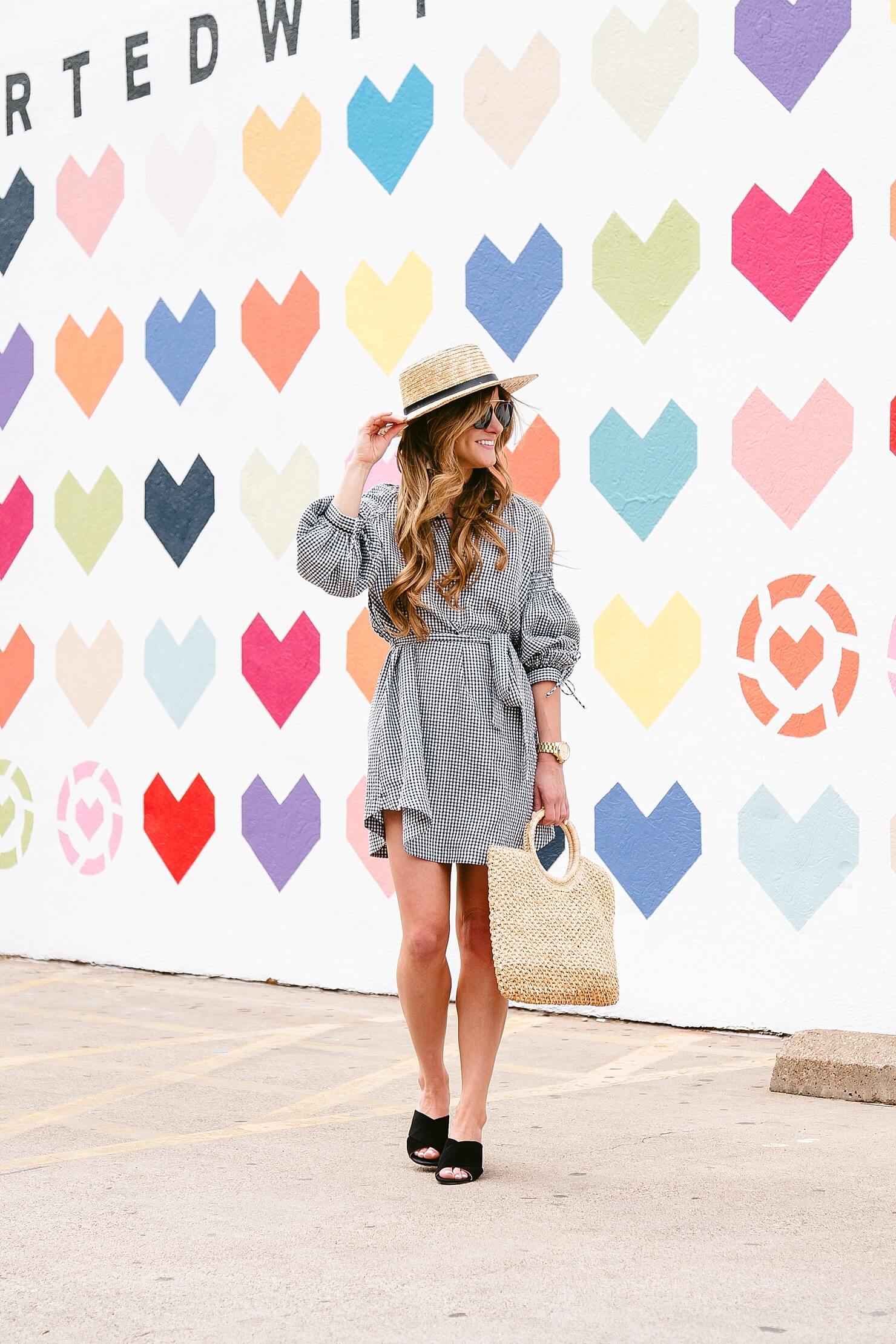 brighton keller wearing gingham dress with mules and straw boater hat and bag 
