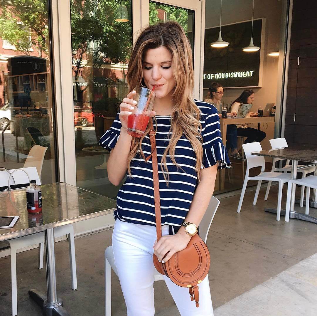 brighton keller wearing striped ruffle sleeve dress with white jeans