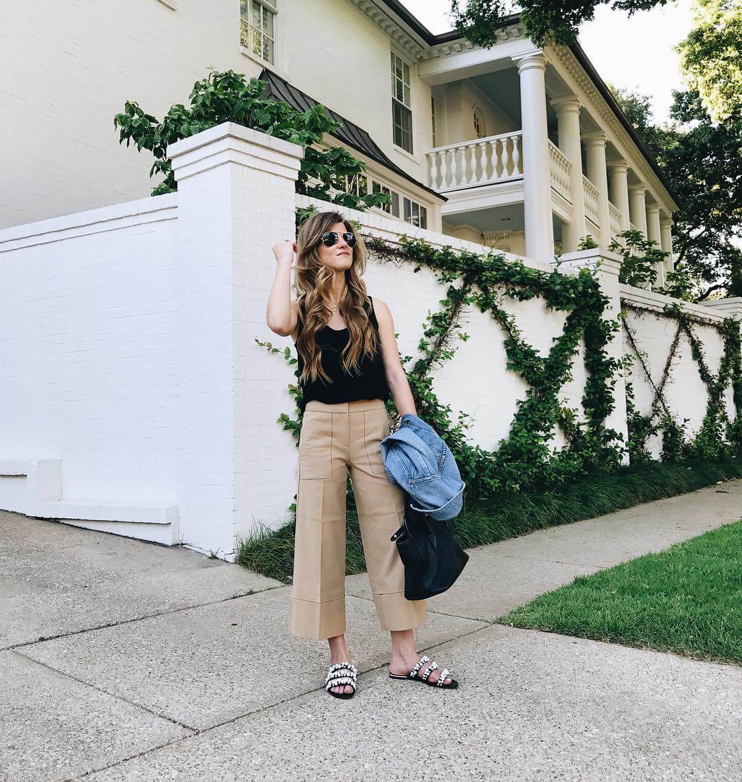 brighton keller wearing tan culottes with black tank and pearl slides 
