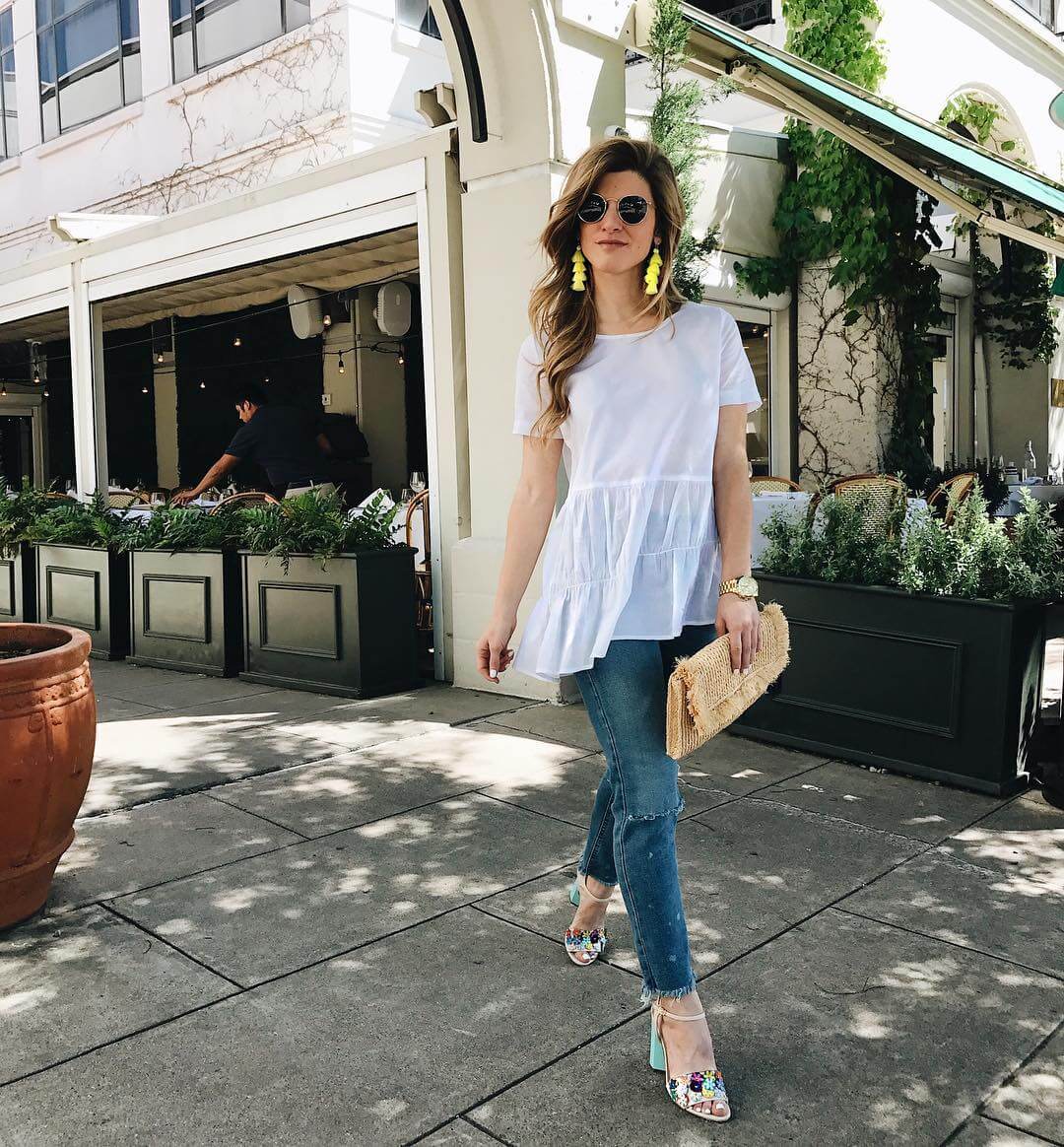 brighton the day wearing white tiered top with jeans and dee keller sandals 