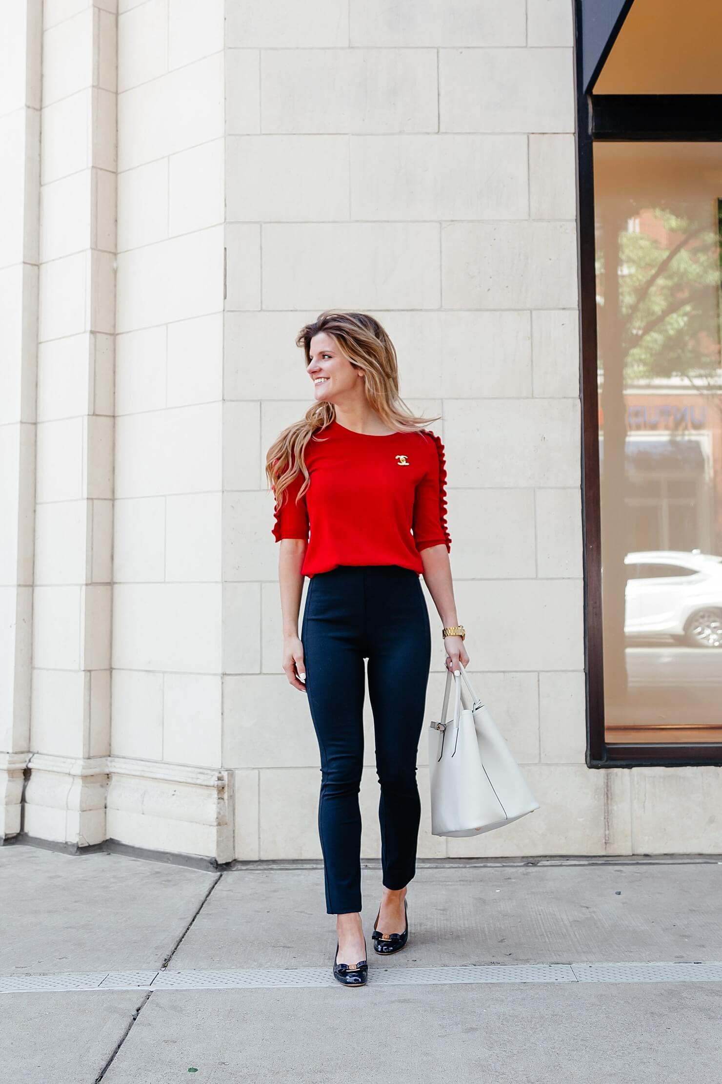 Ruffle sleeve sweater with navy trim pants and navy flats 