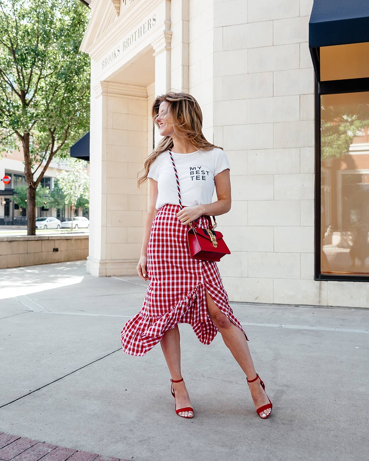 graphic white tee with red gingham skirt and heels 