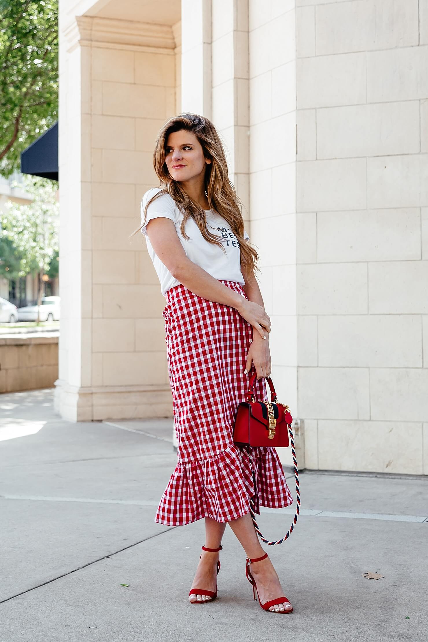 Peplum midi skirt with graphic tee and red gucci bag