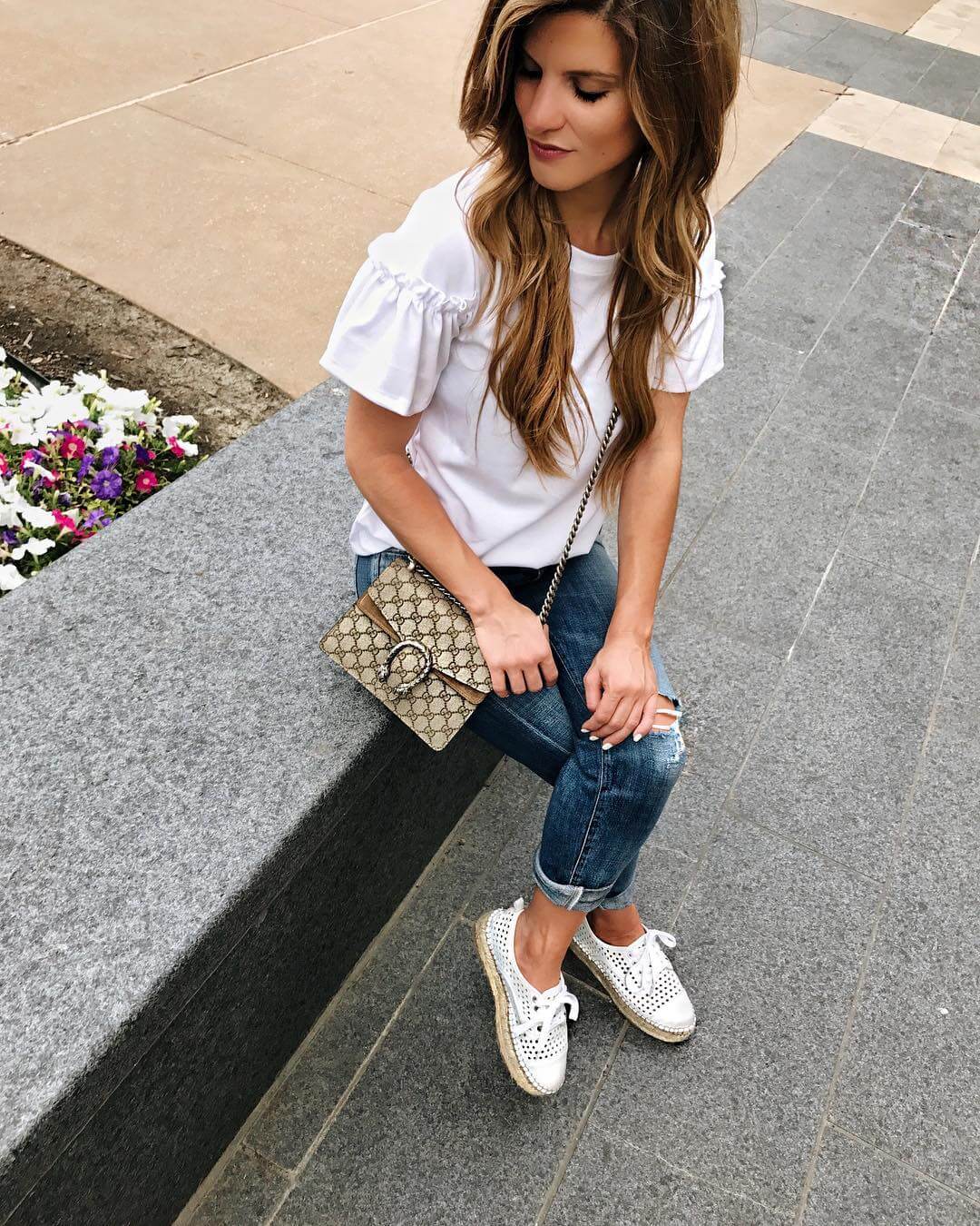 running around town in white flutter sleeve tee with jeans 