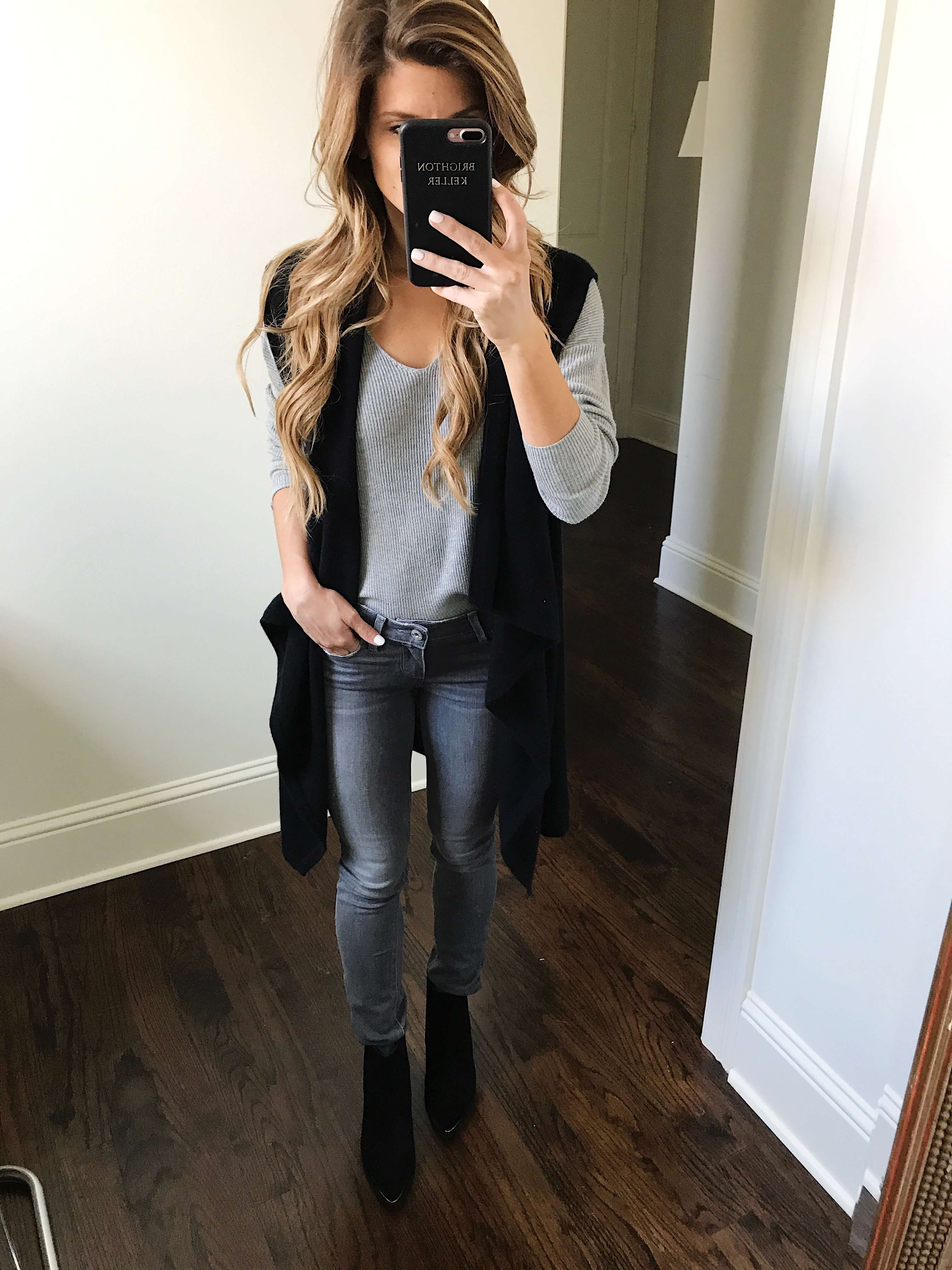 black long vest with grey sweater and grey jeans and marc fisher booties