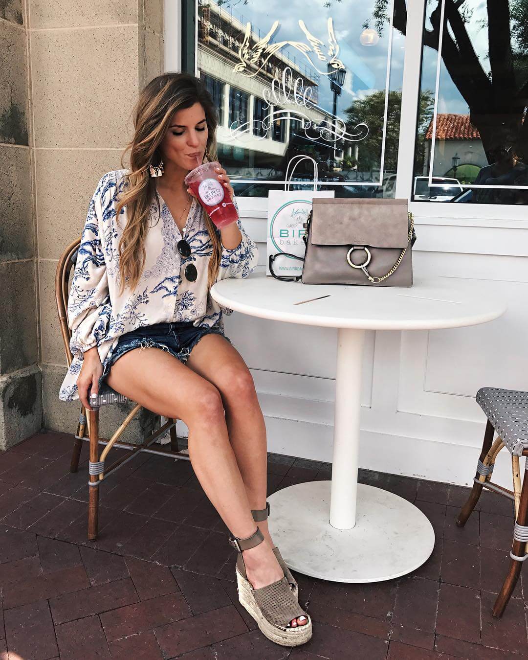 brighton keller wearing free people top with denim shorts and marc fisher wedges at bird bakery