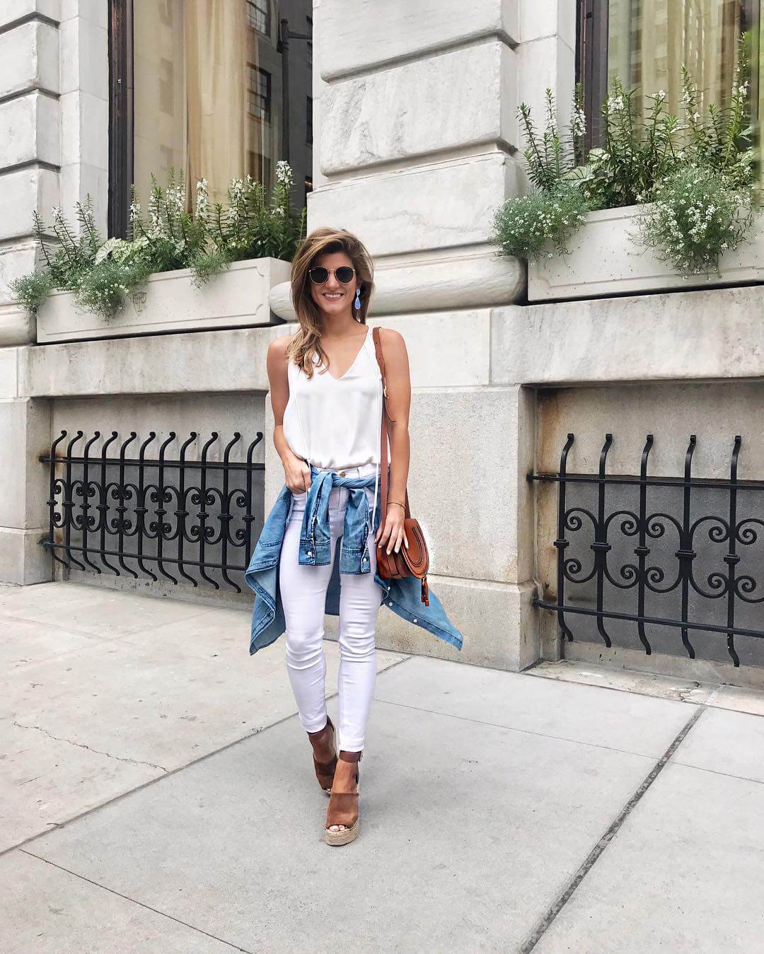 all white outfit with denim shirt around the waist
