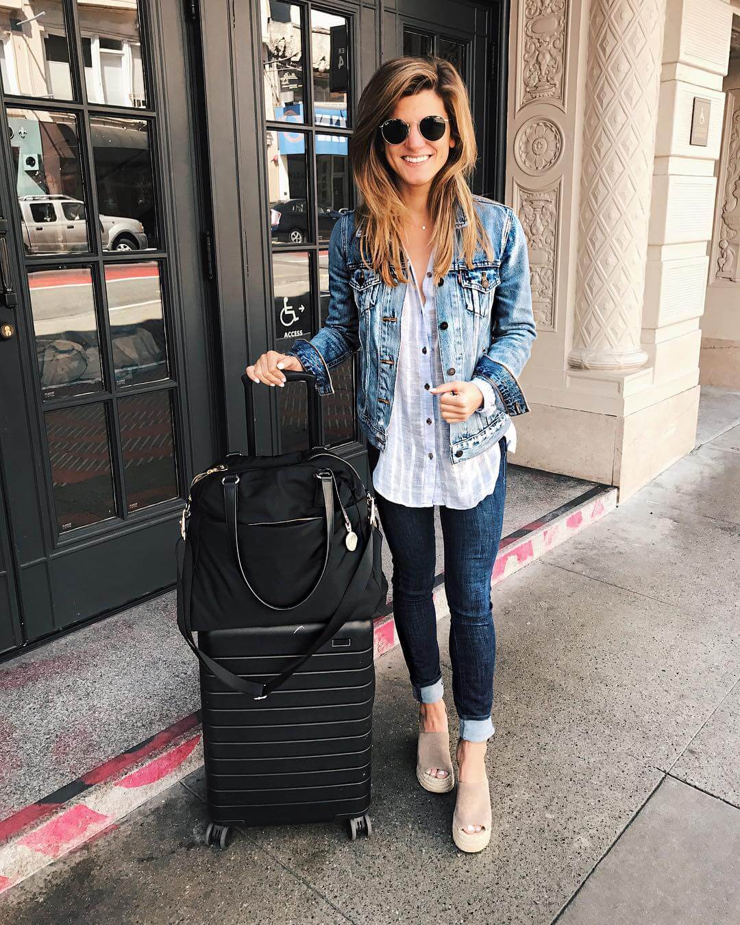 landed in san francisco wearing denim on denim outfit with denim jacket, jeans, and button up 