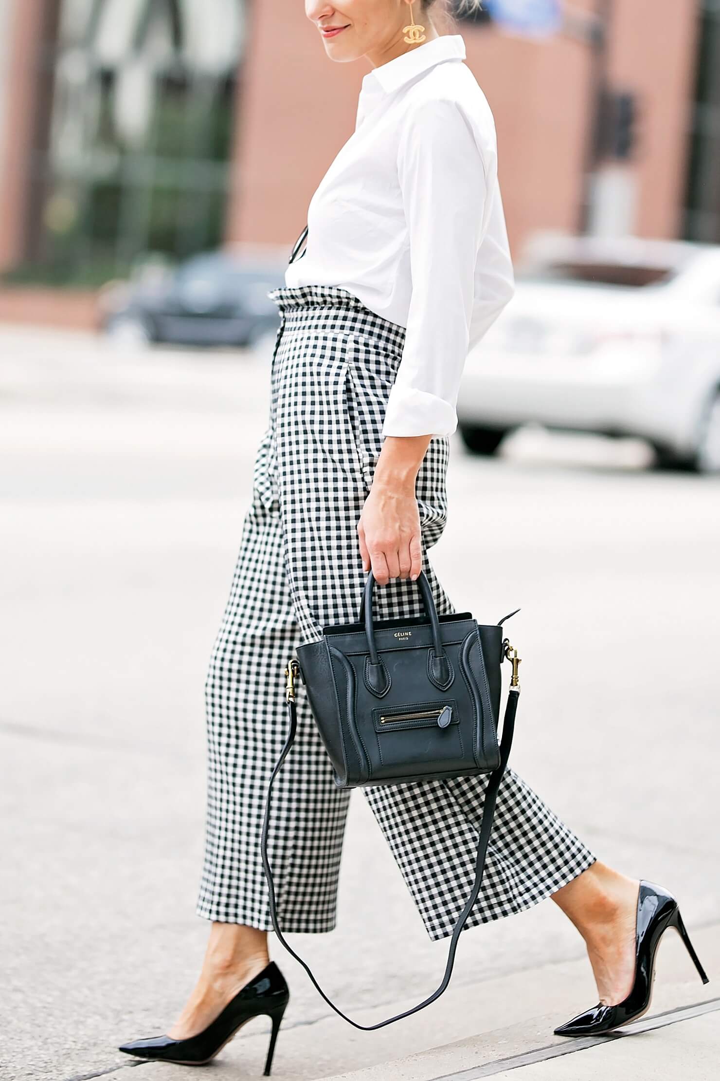 brighton keller wearing gingham pants with white button down and black pointy toe pumps 