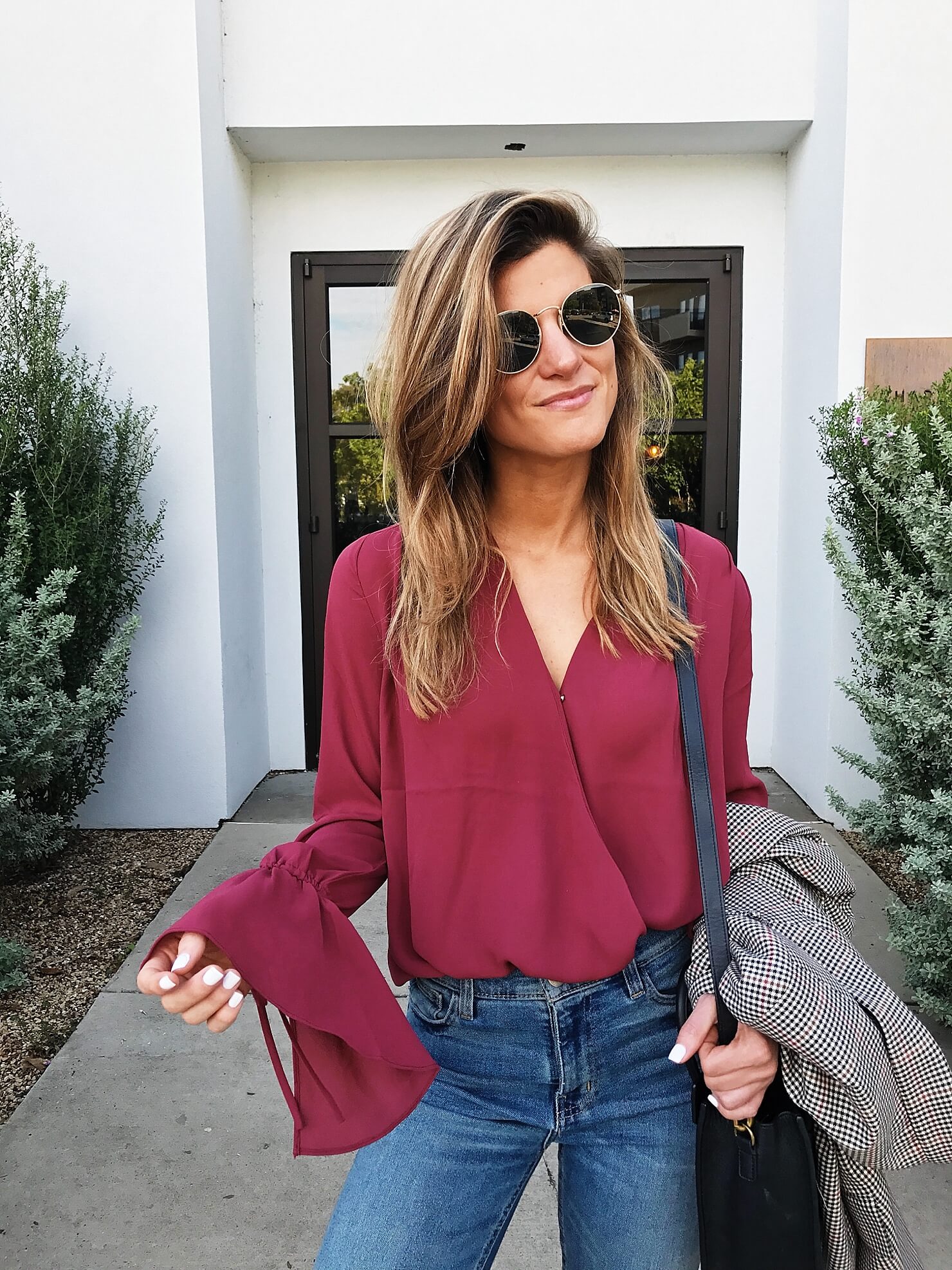 burgundy surplice top with bell sleeve detail