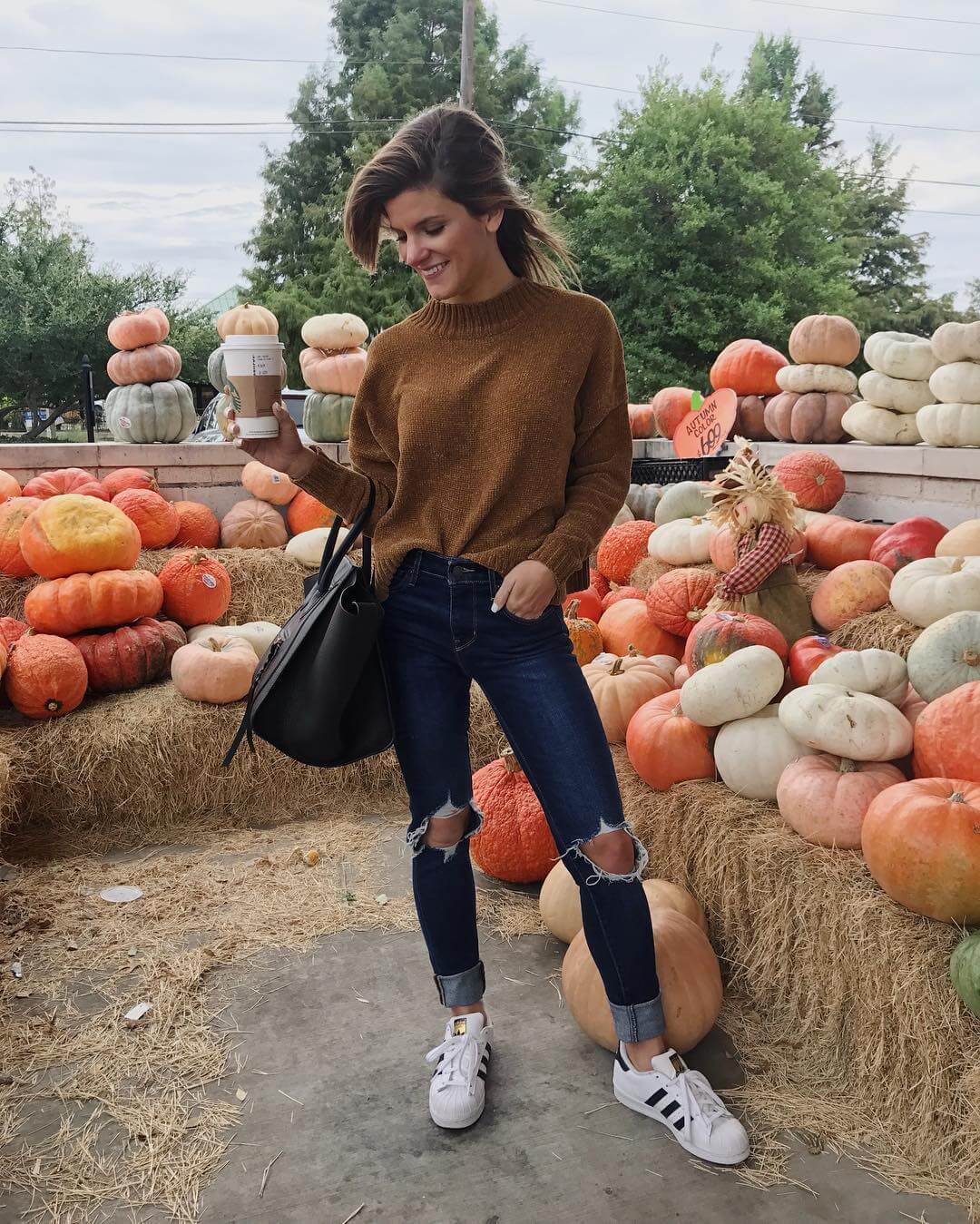 brighton keller dallas fashion blogger wearing fall outfit with adidas superstar sneakers, high-waisted levi's jeans and gold sweater