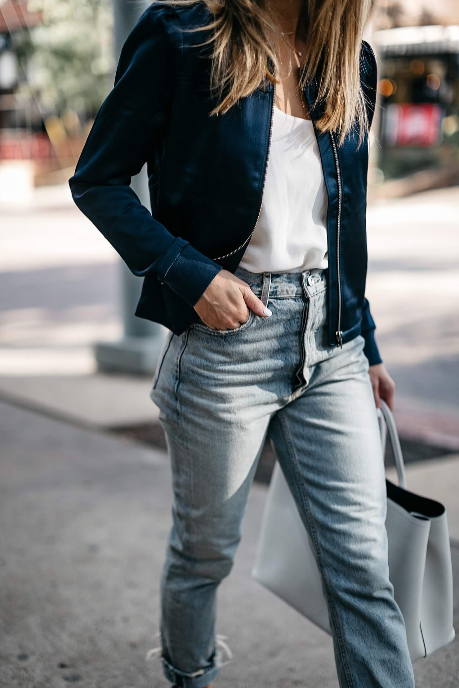 satin bomber, white t-shirt, light jeans, and low blue heel 