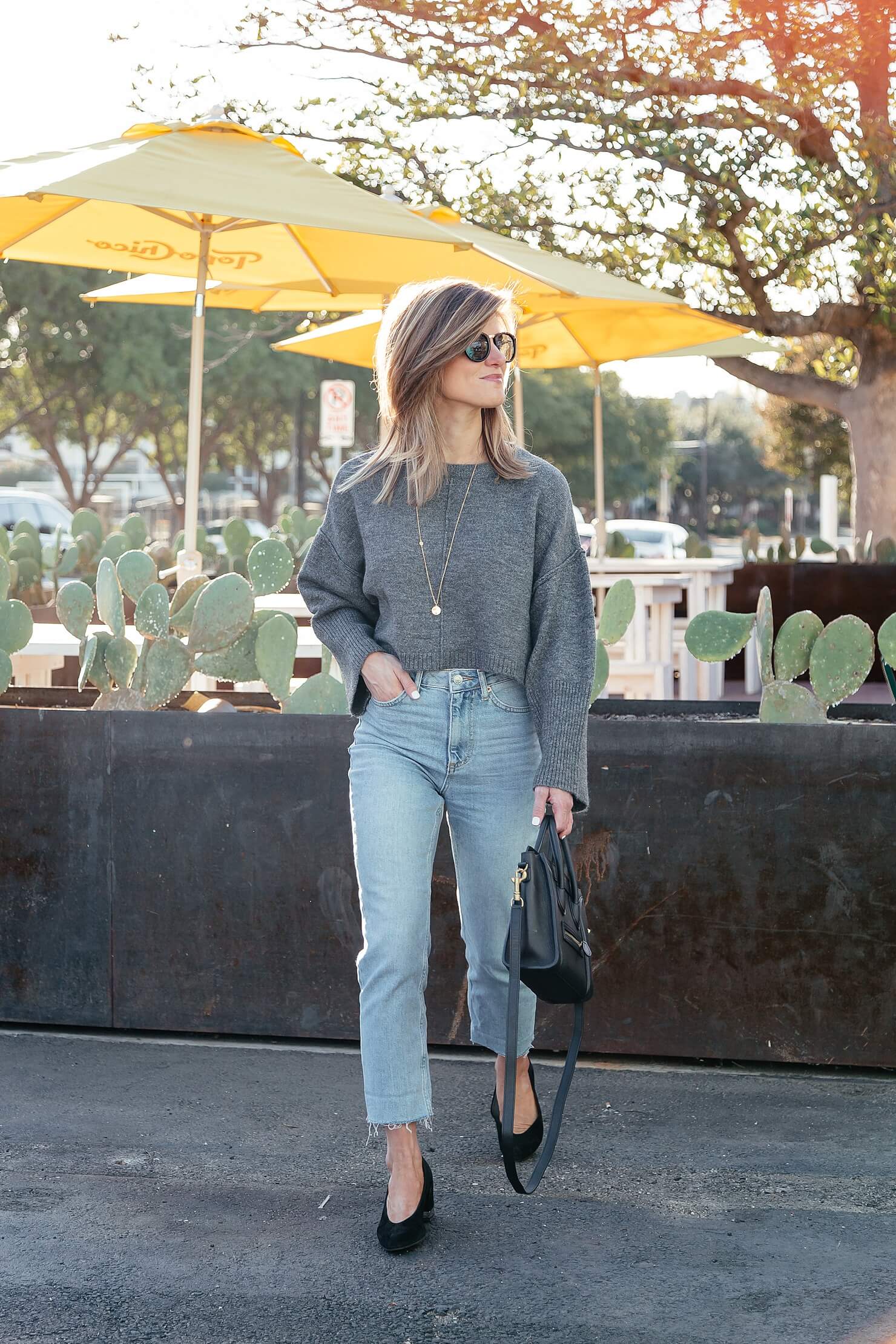 grey cropped sweater, mom jeans. and black kitten heel