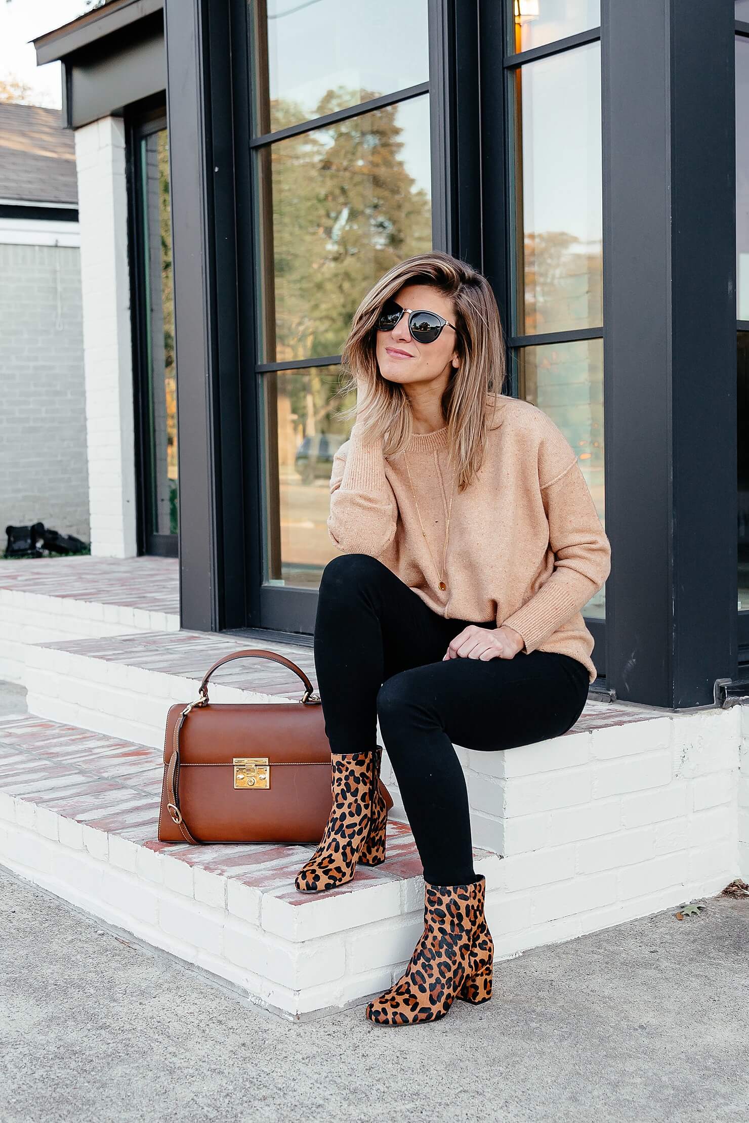 camel sweater, black jeans, leopard booties, brown leather bag, and black sunglasses