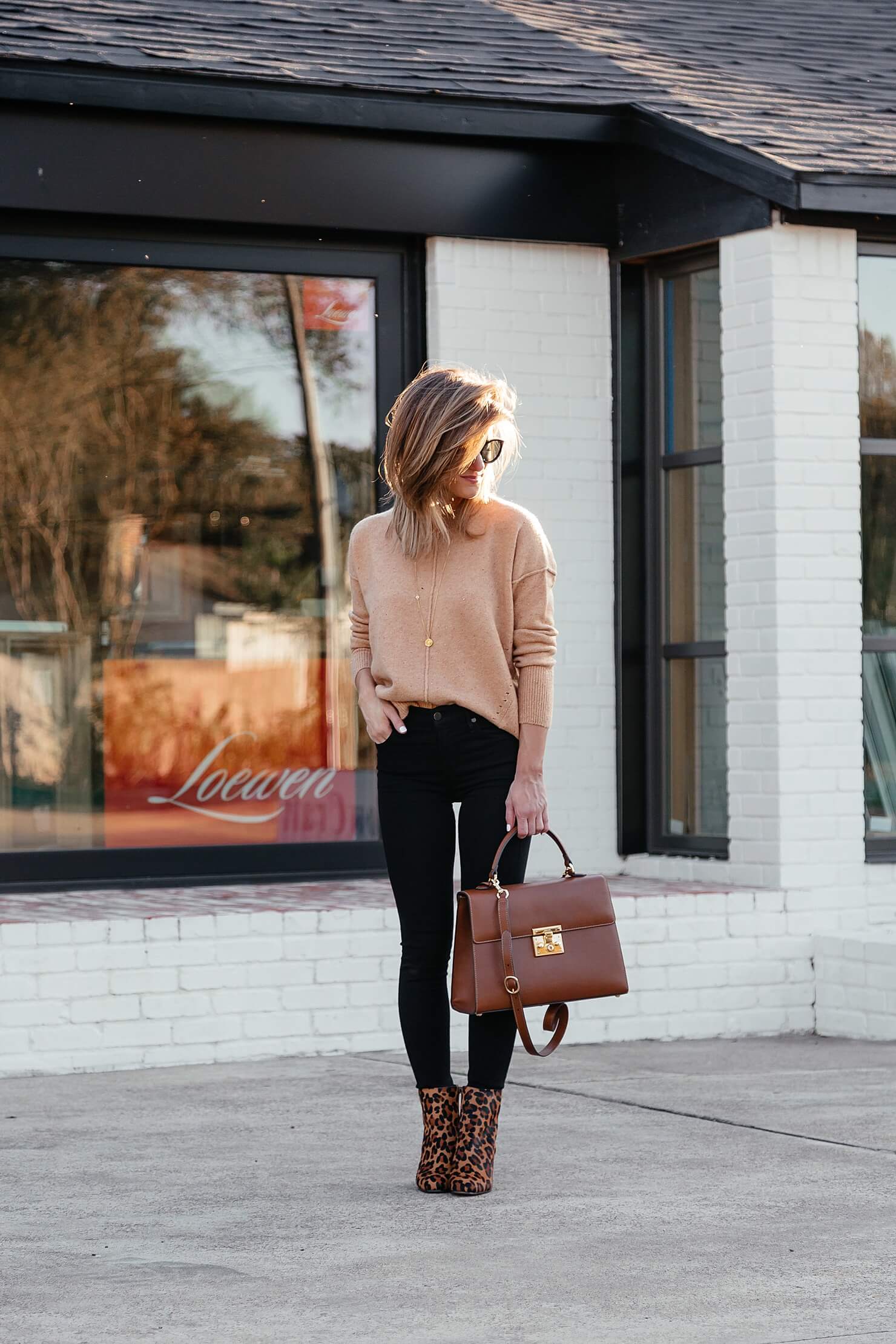 camel sweater, black jeans, leopard booties, brown leather bag, and black sunglasses 