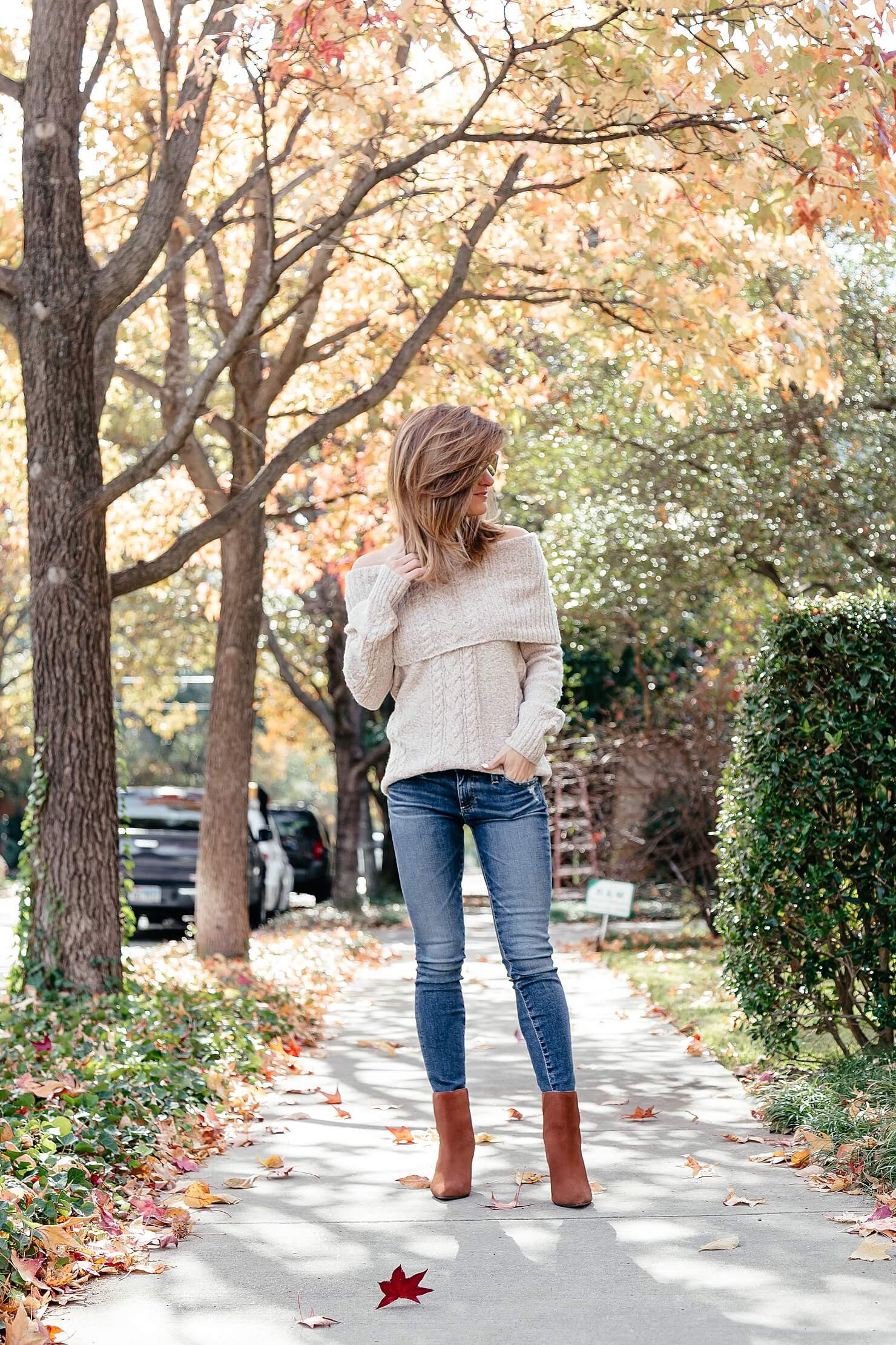 off the shoulder cable knit sweater, ag jeans, and brown heel booties