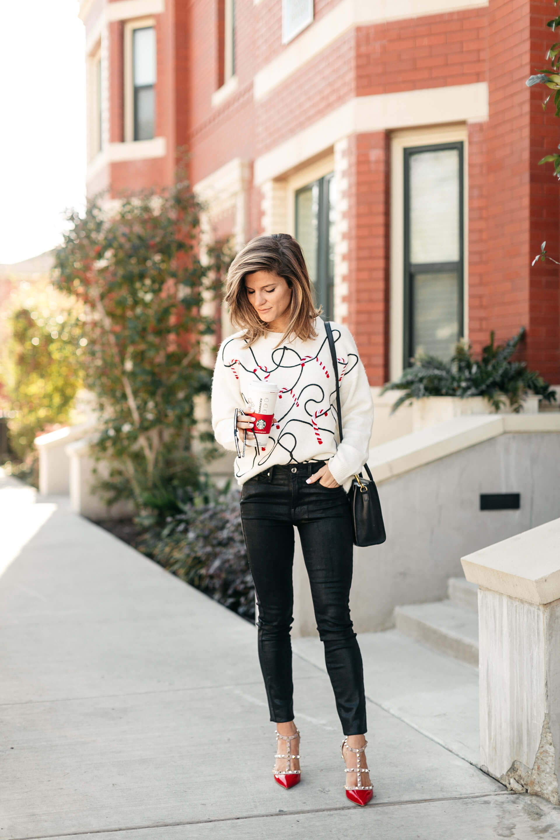 candy cane christmas sweater, black jeans, valentino pumps, and celine mini bag