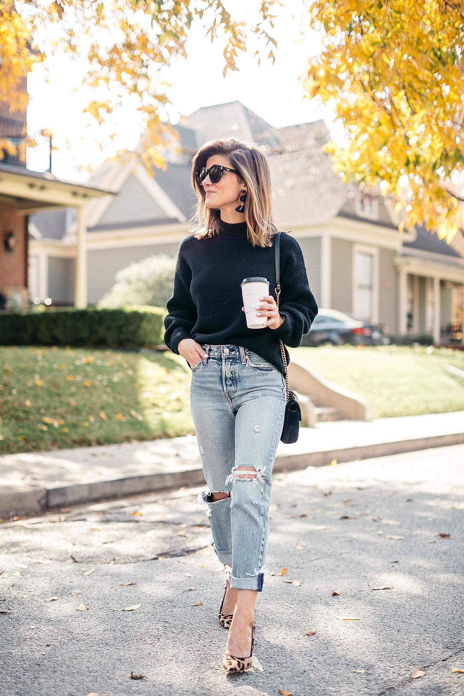 black sweater, distressed levi jeans, leopard pumps and gucci cross body 