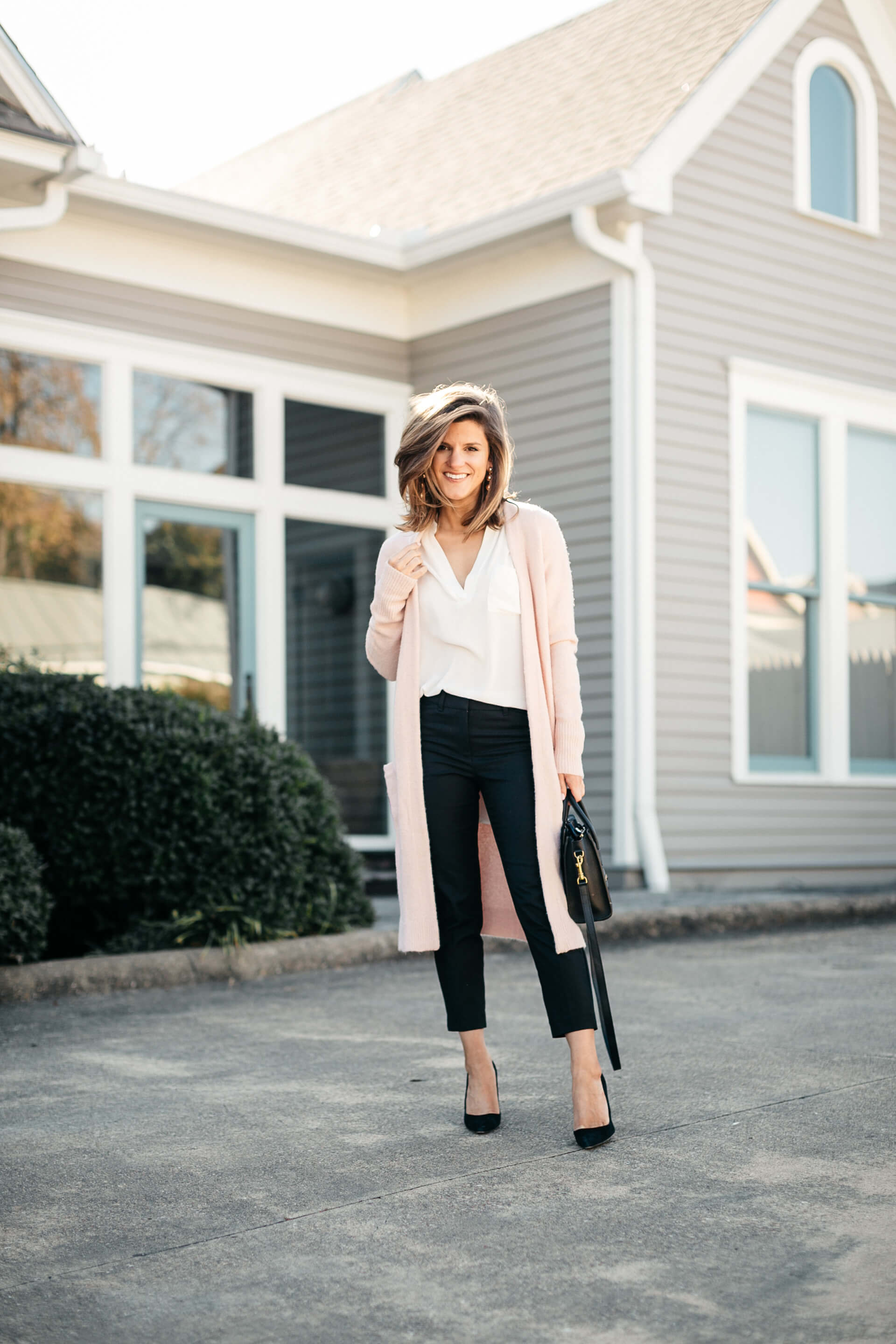 pink cardigan, white lush tunic, and black pants