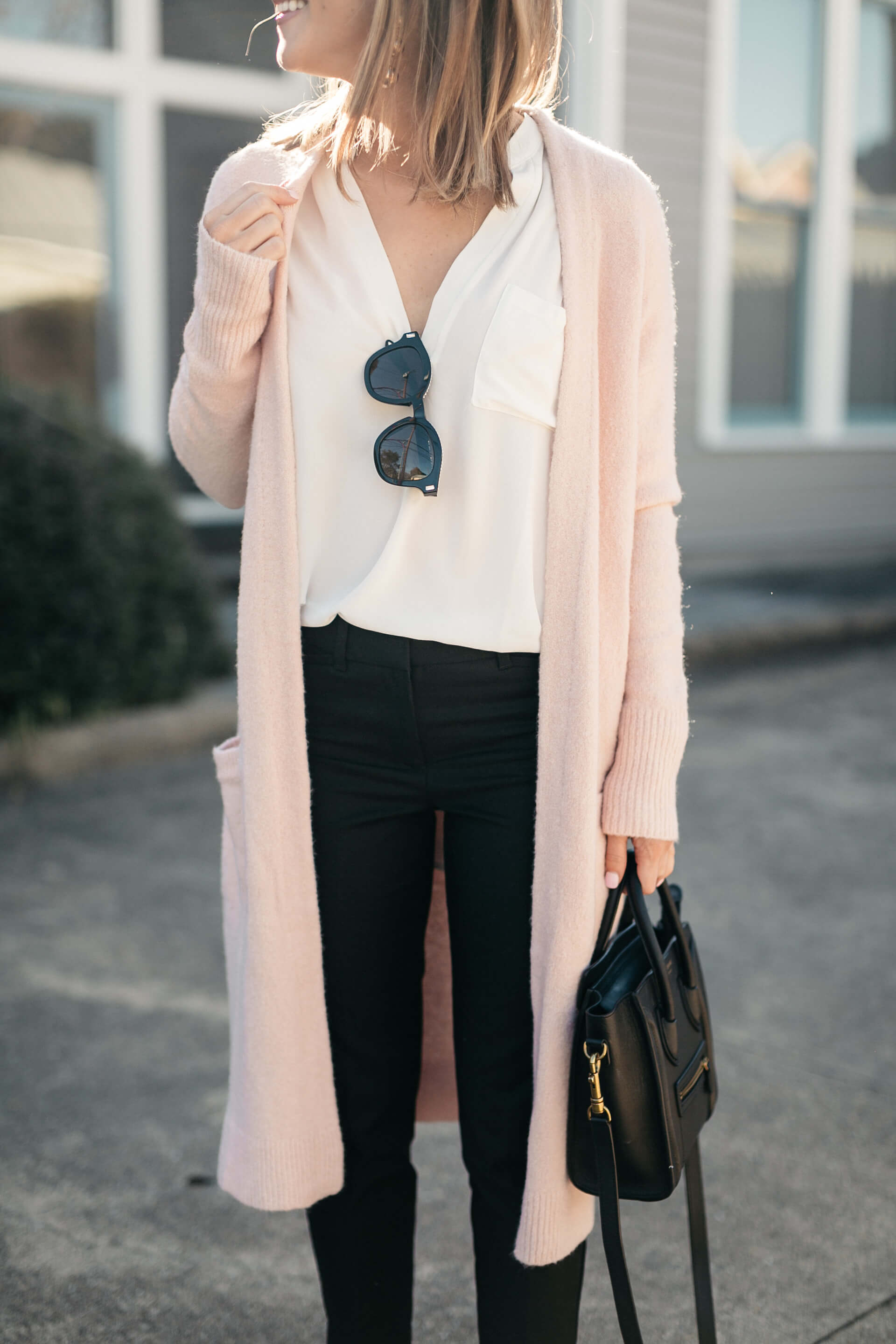 pink cardigan, white lush tunic, and black pants
