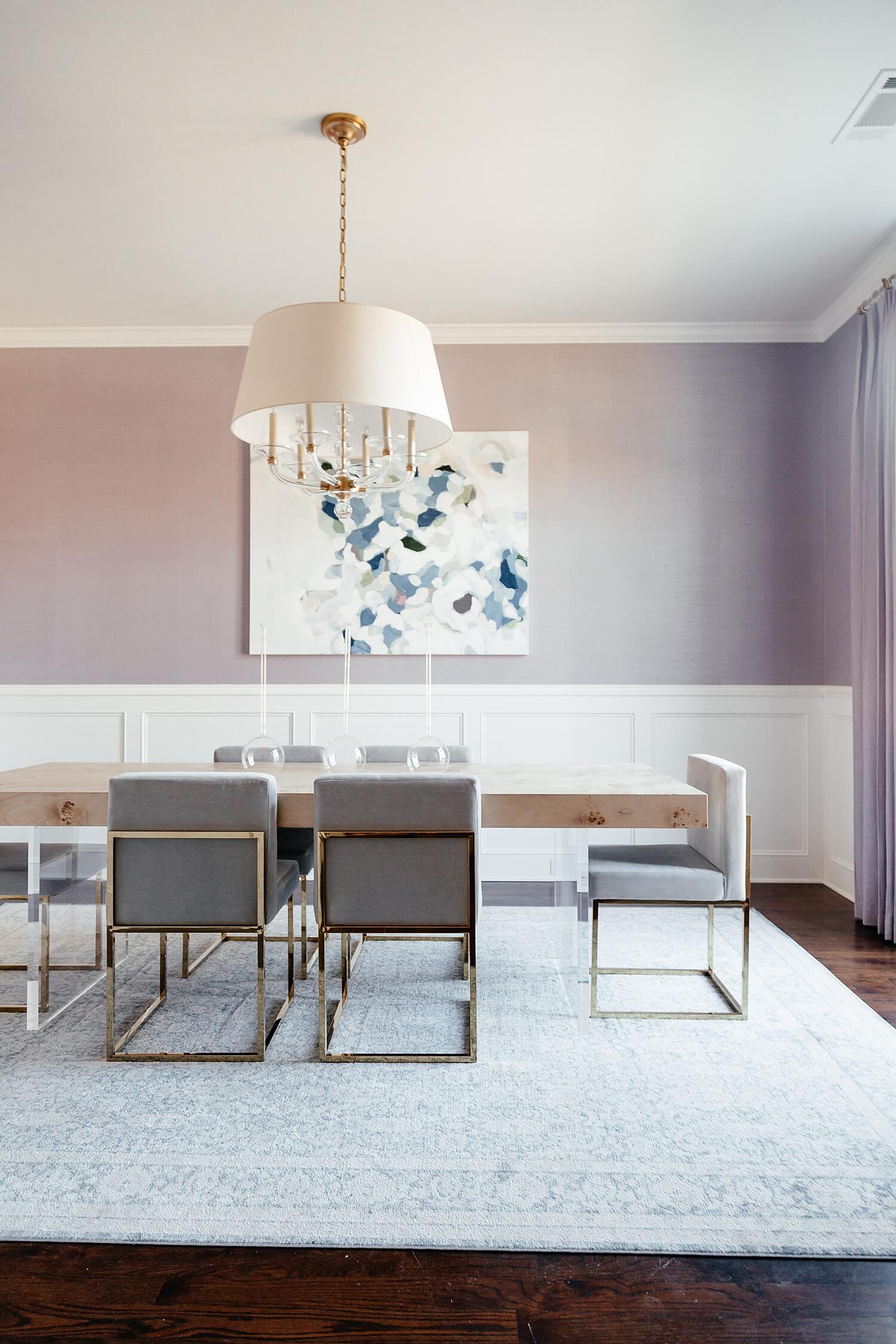 brighton keller dining room burl wood dining room table grey velvet chairs blue rug purple walls