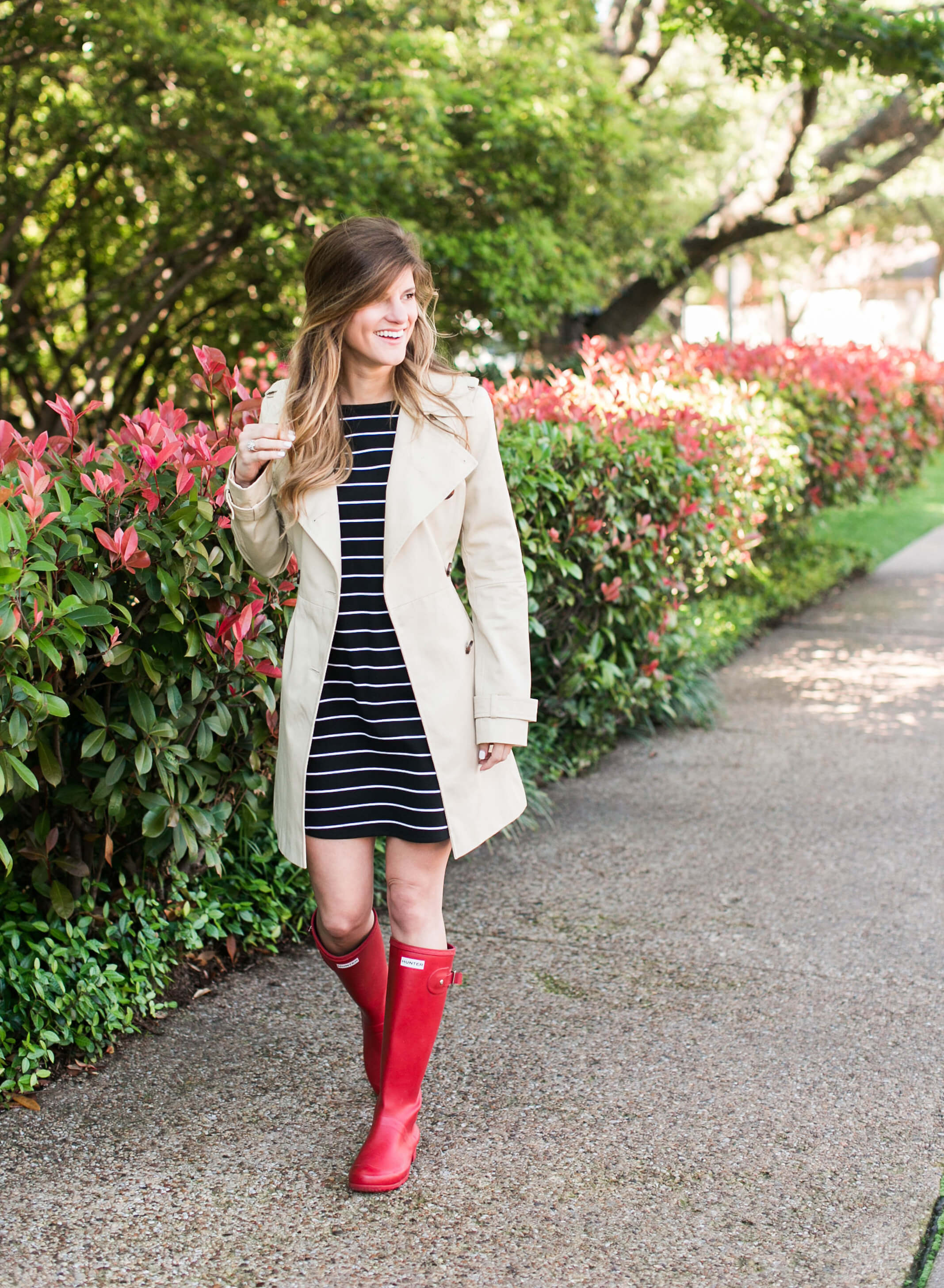 trench coat, black and white striped dress, red hunter boots