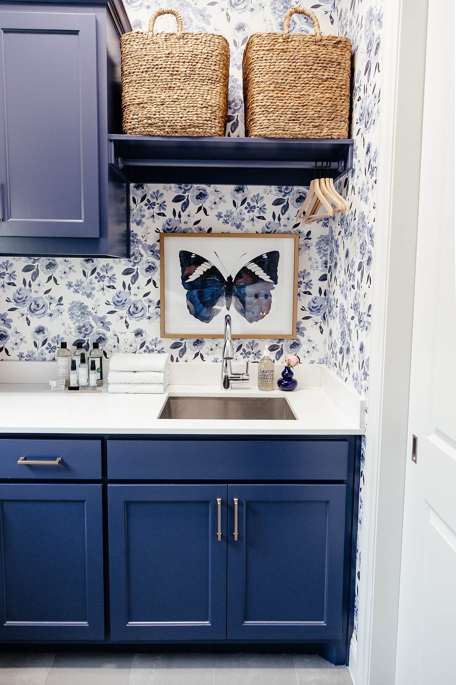 brighton keller laundry room blue and white wallpaper blue painted cabinets