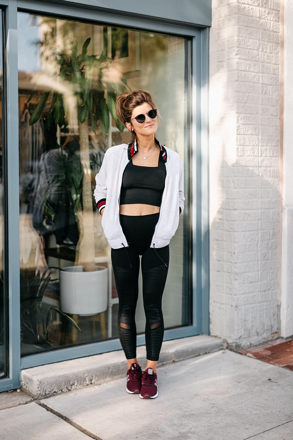 athleisure outfit all black high waisted leggings and sports bra with burgundy new balance sneakers