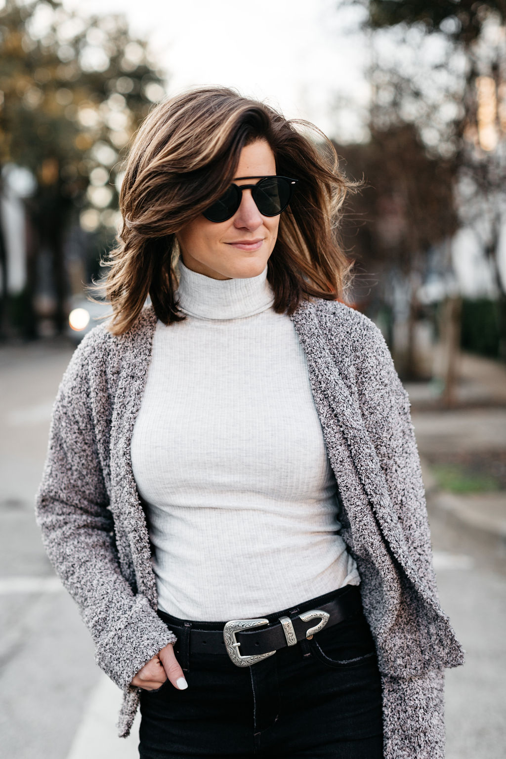 wearing a turtleneck with a cropped cardigan with back jeans western belt