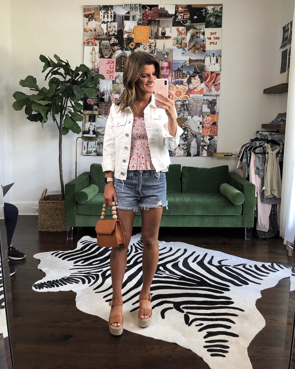jean shorts summer outfit with smocked floral top and white denim jacket