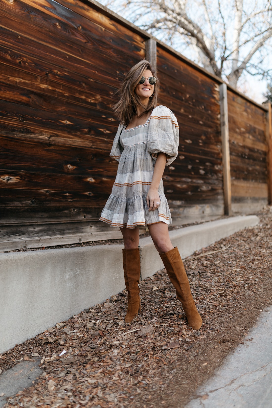 brighton keller wearing free people spring dress puff sleeves from verishop with tall boots
