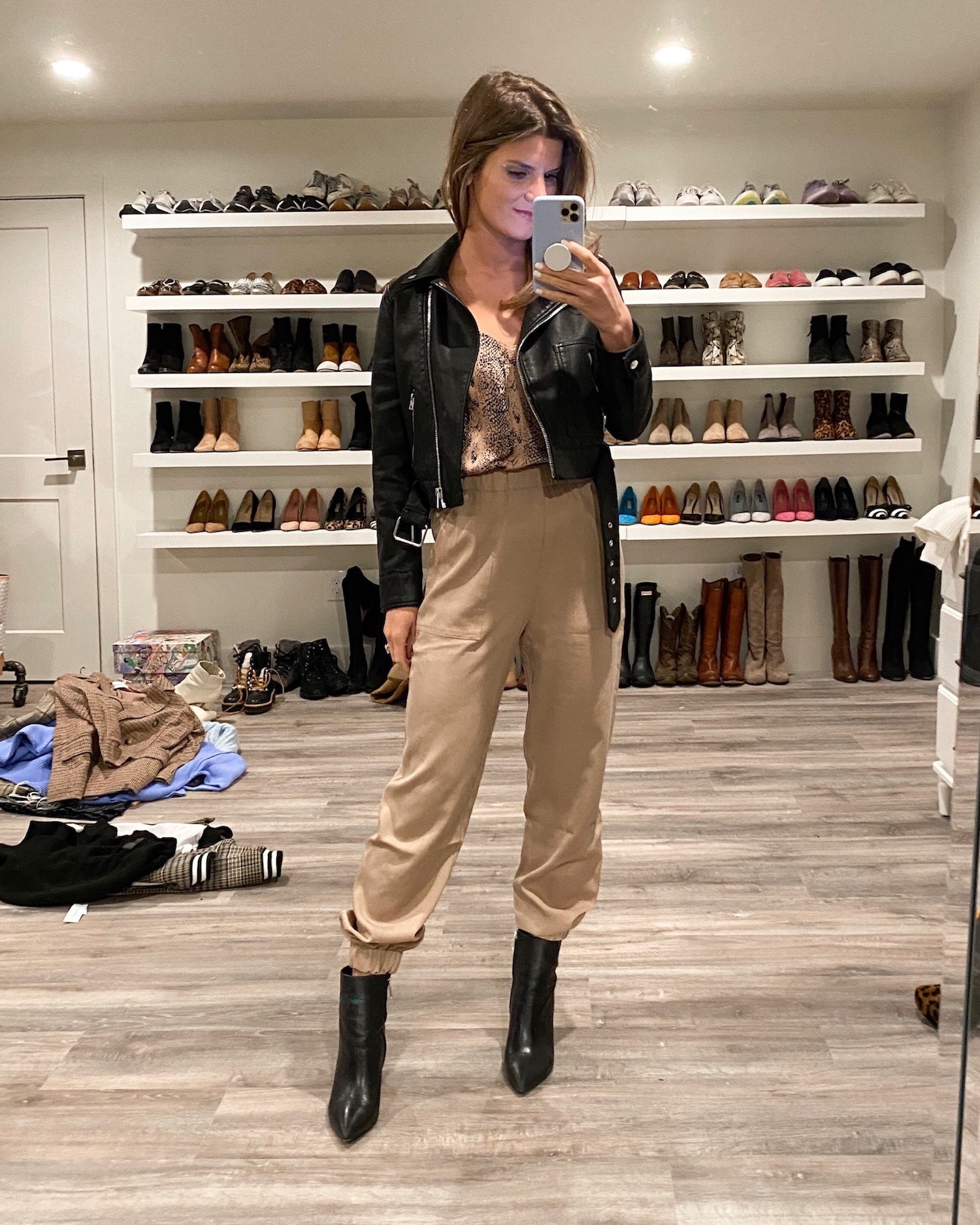 Brighton Keller wearing tan joggers, camisole, leather jacket and black booties